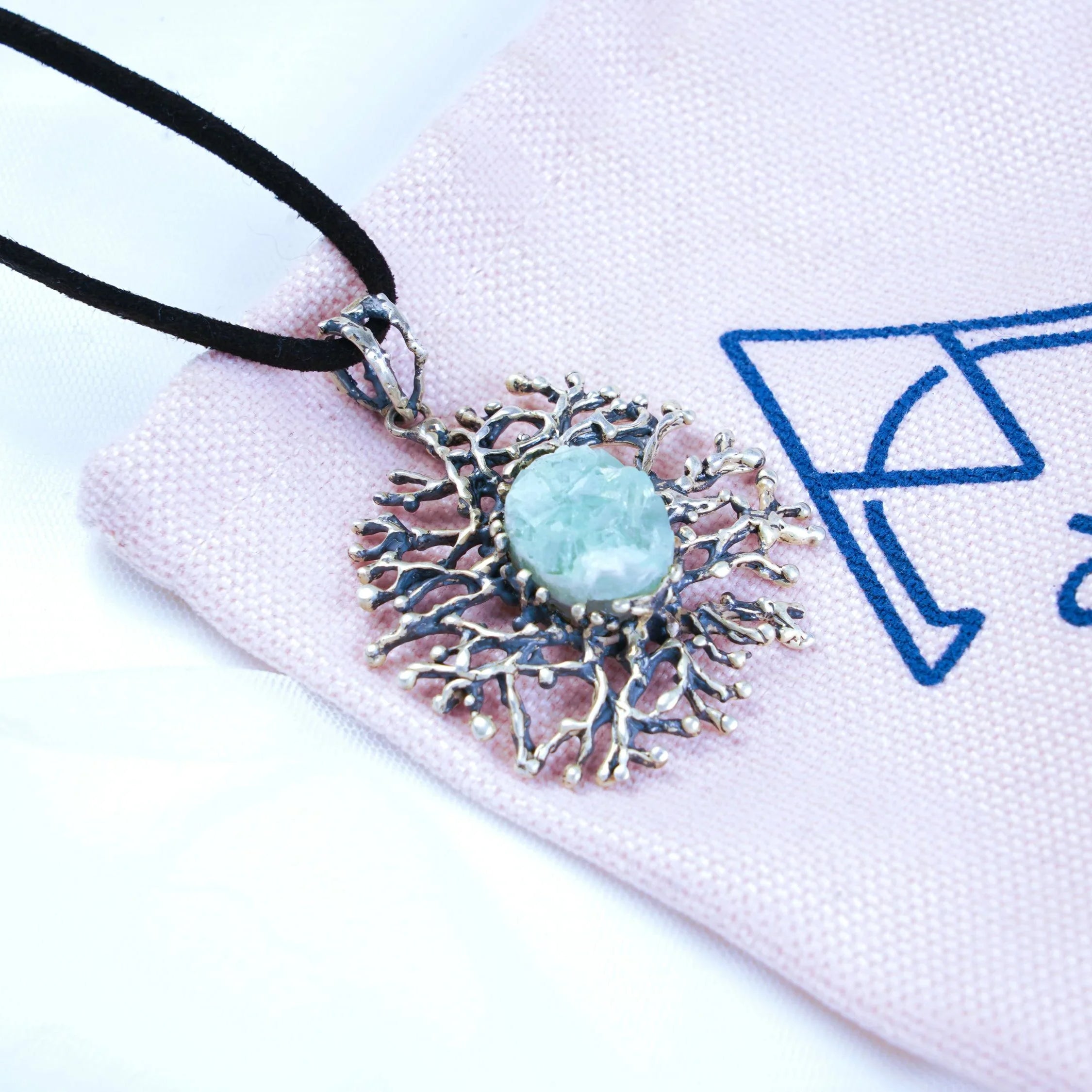 Aquamarine necklace on branded fabric aesthetic jewelry presentation