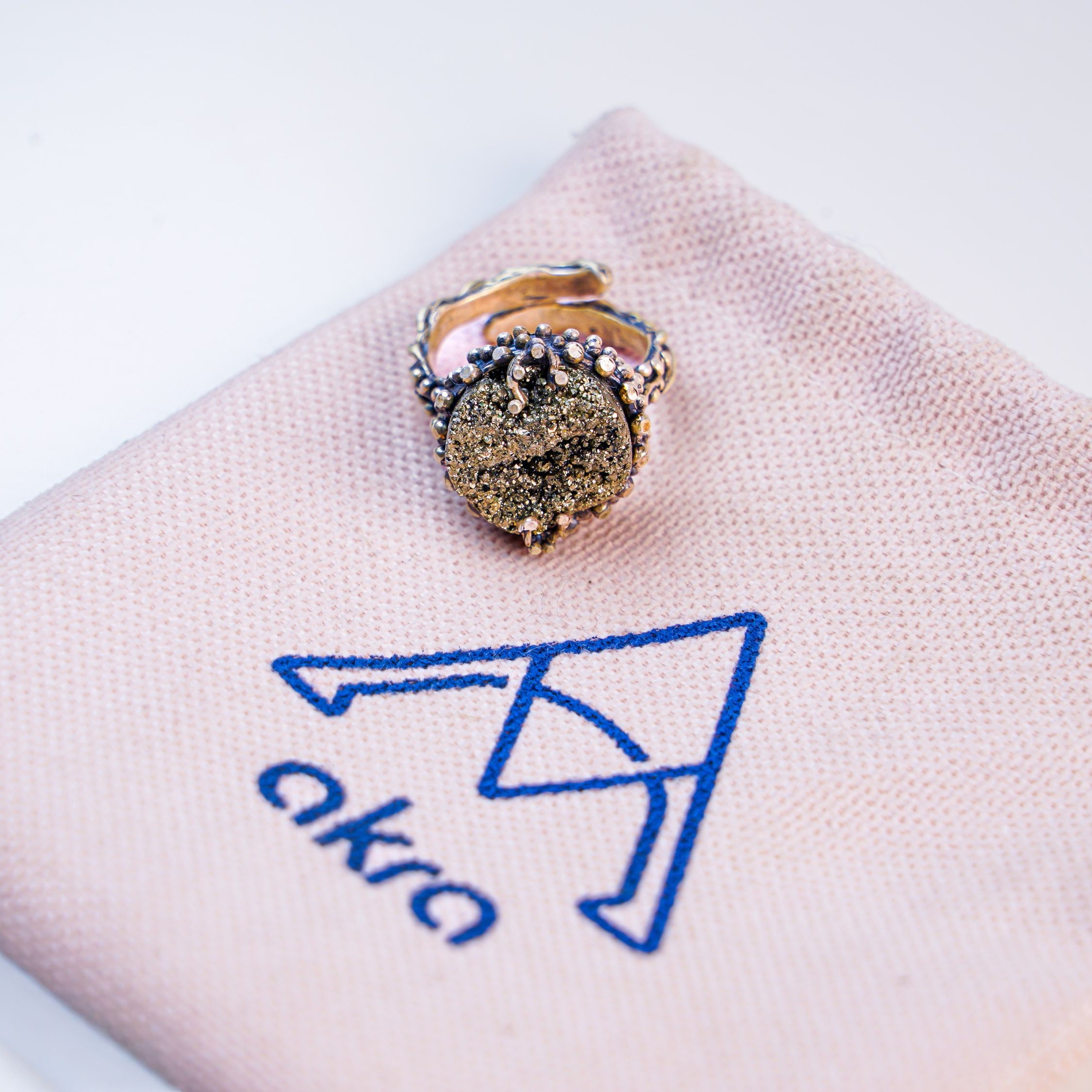 Pyrite ring on jewelry pouch branded packaging presentation akra jewelry