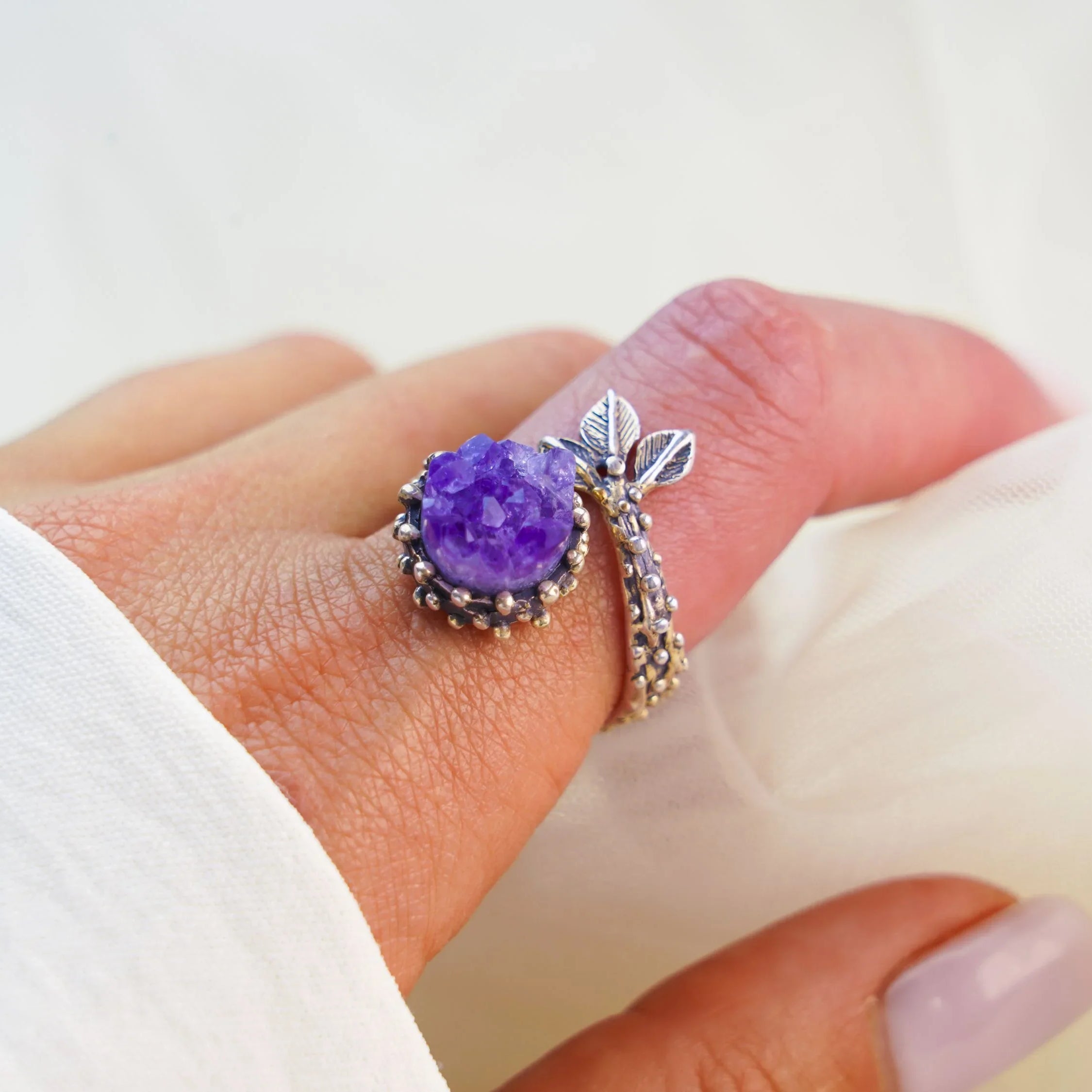 Amethyst ring worn on finger adjustable sterling silver purple gemstone jewelry
