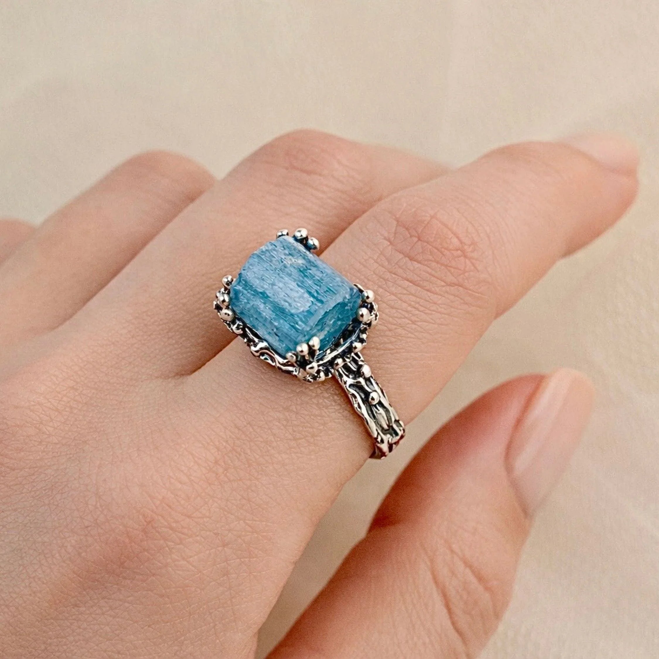 Aquamarine ring worn on hand adjustable sterling silver blue gemstone