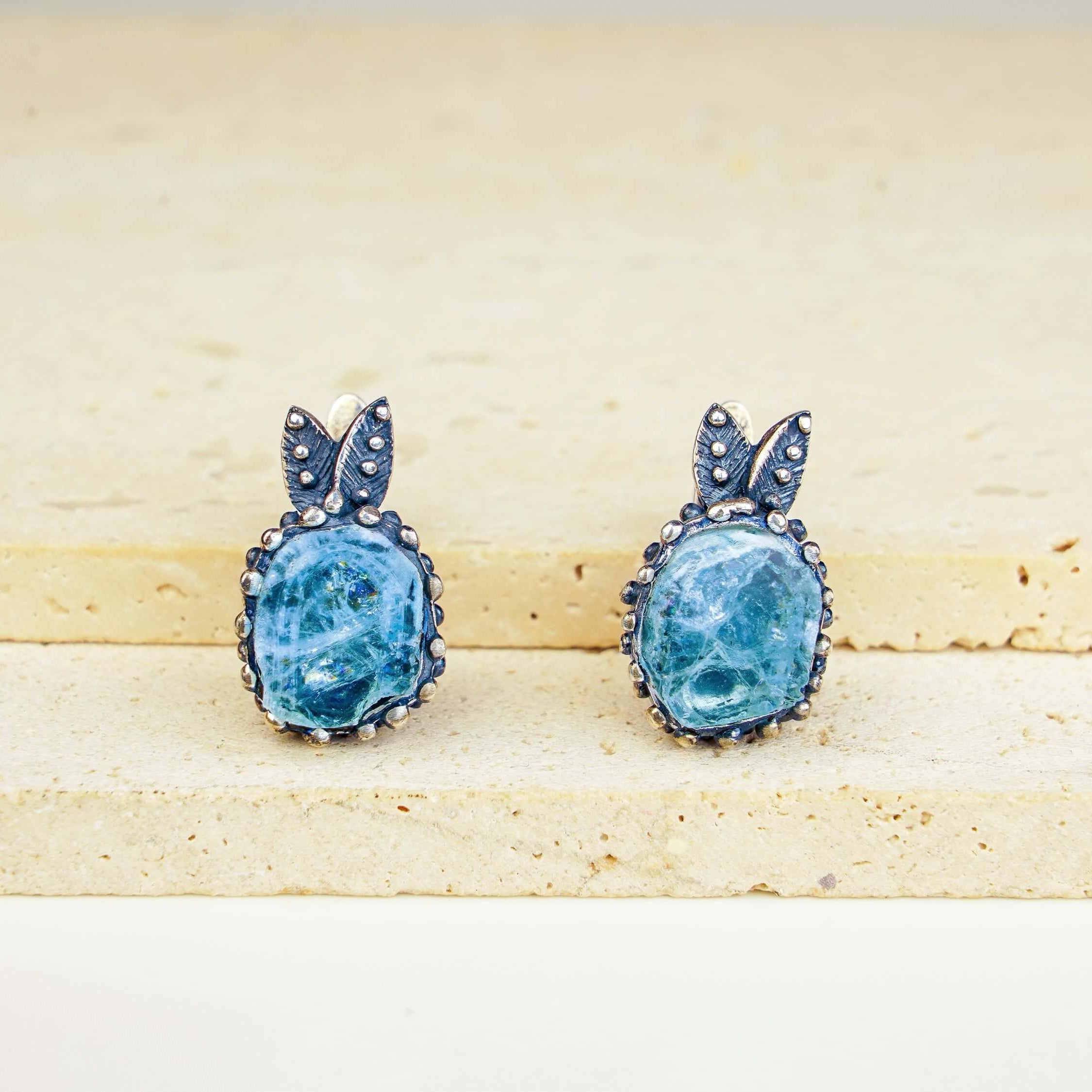 Handmade light blue aquamarine earrings in ornate silver setting by Akra Gems