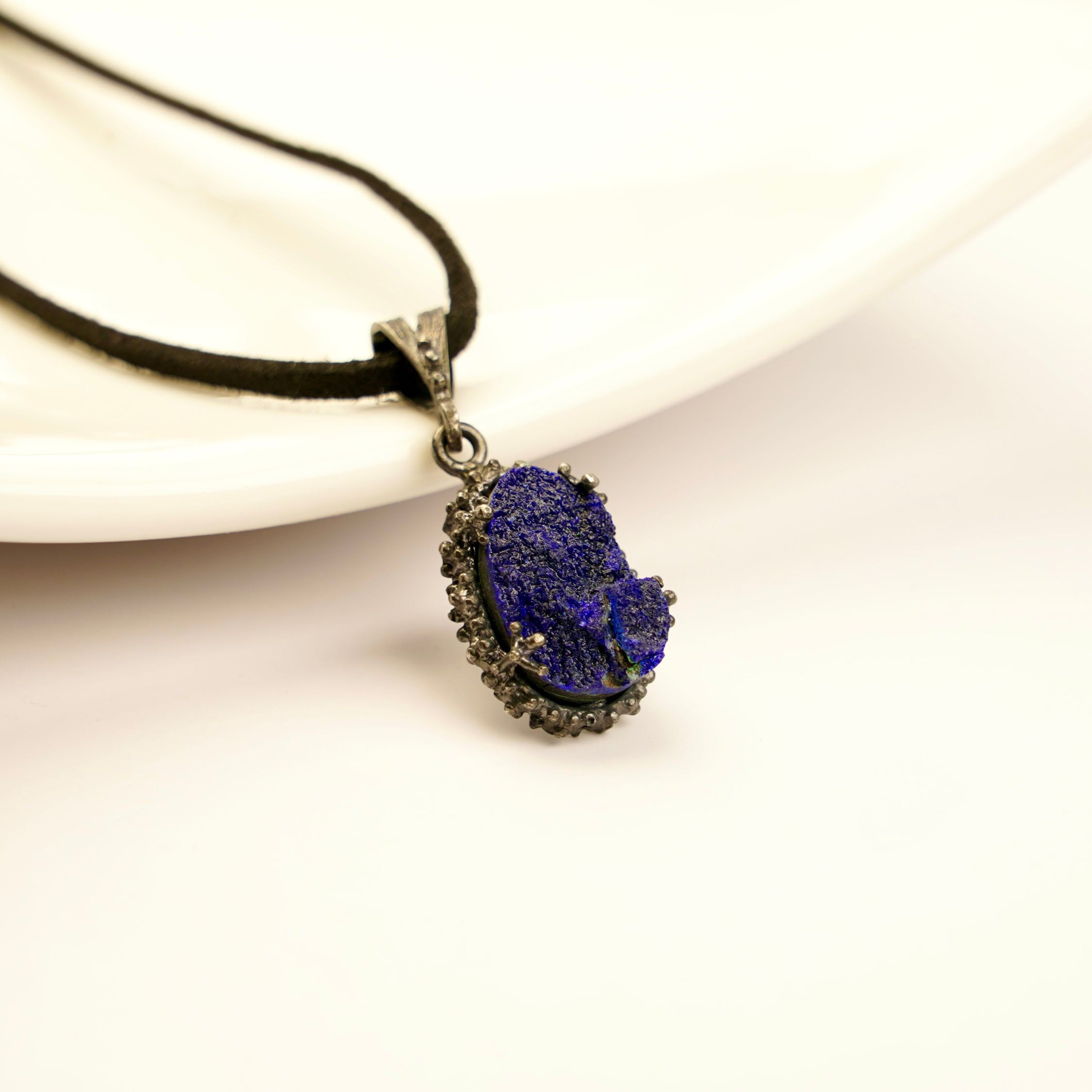 lapis lazuli pendant necklace on display, raw blue crystal sterling silver jewelry