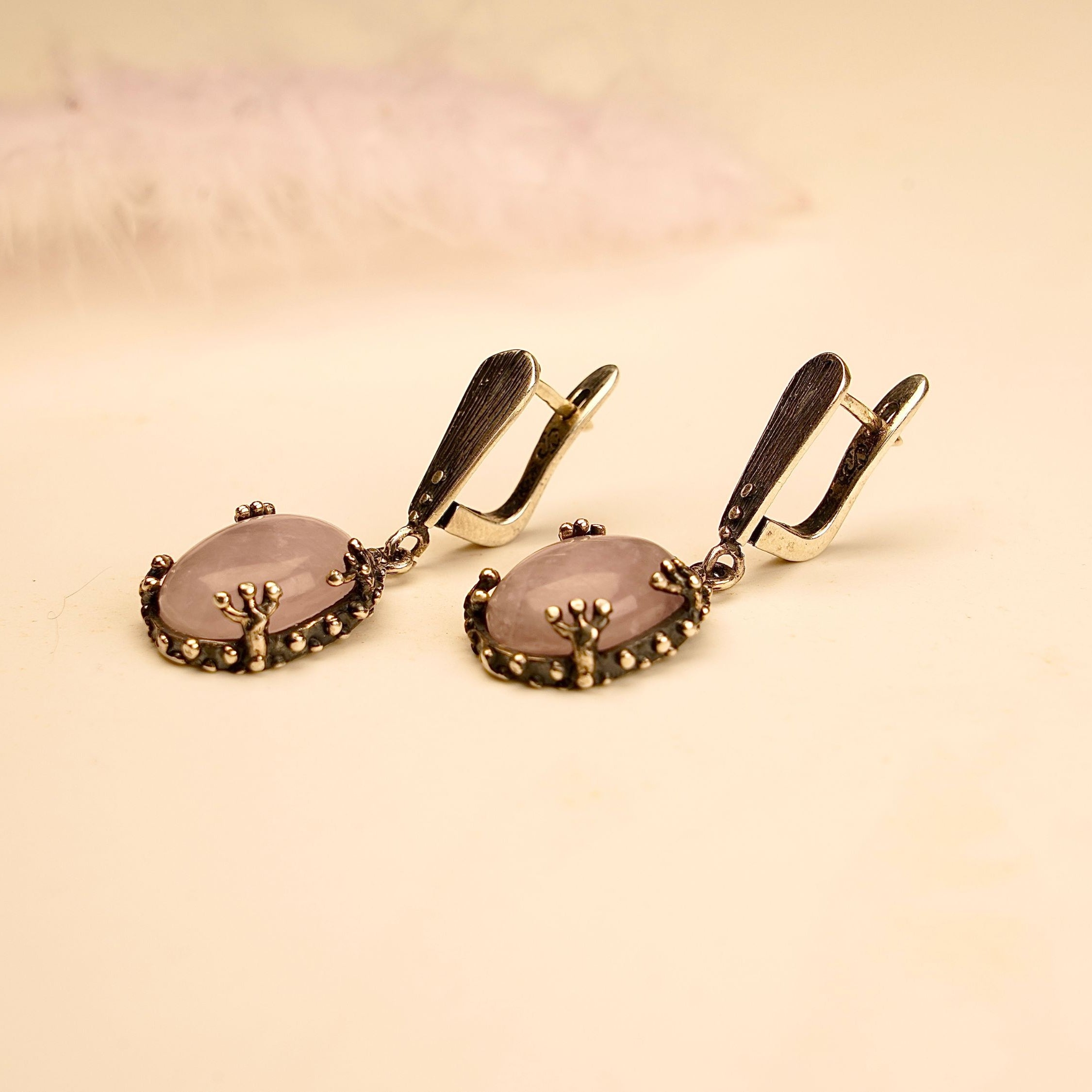 rose quartz earrings on display, elegant pink gemstone silver drop earrings