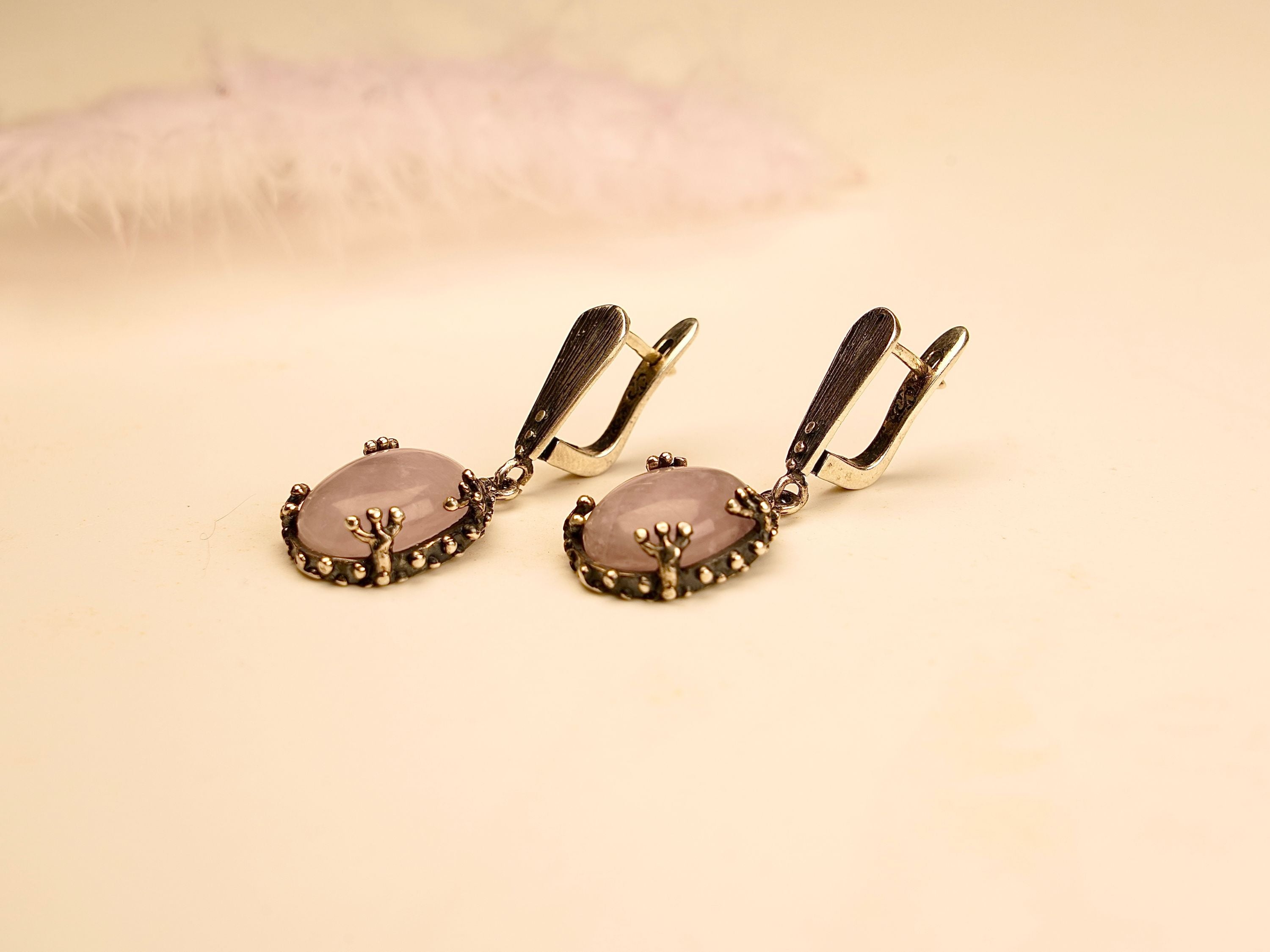 rose quartz earrings on display, elegant pink gemstone silver drop earrings