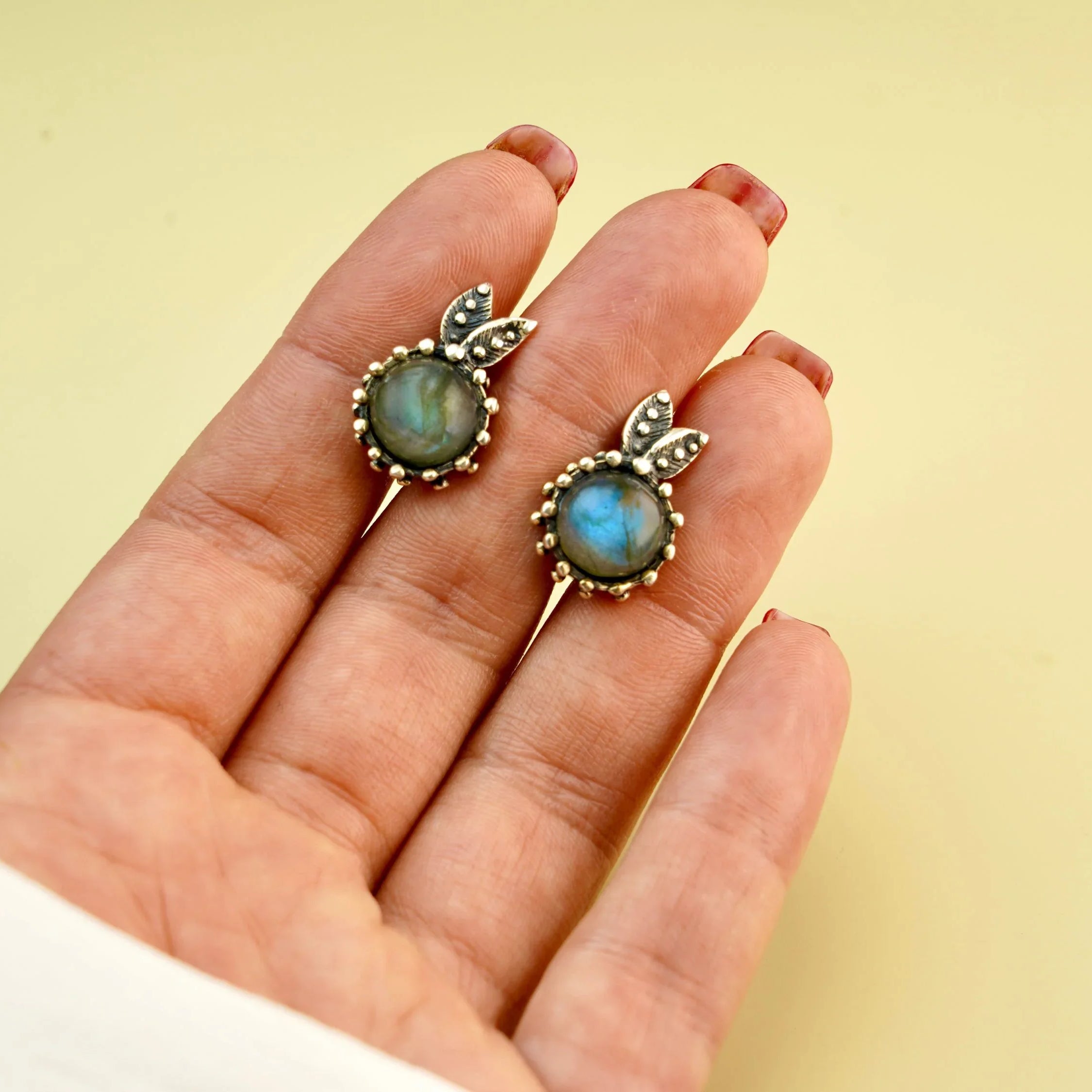 Handmade labradorite earrings worn on hand size reference blue flash gemstone jewelry