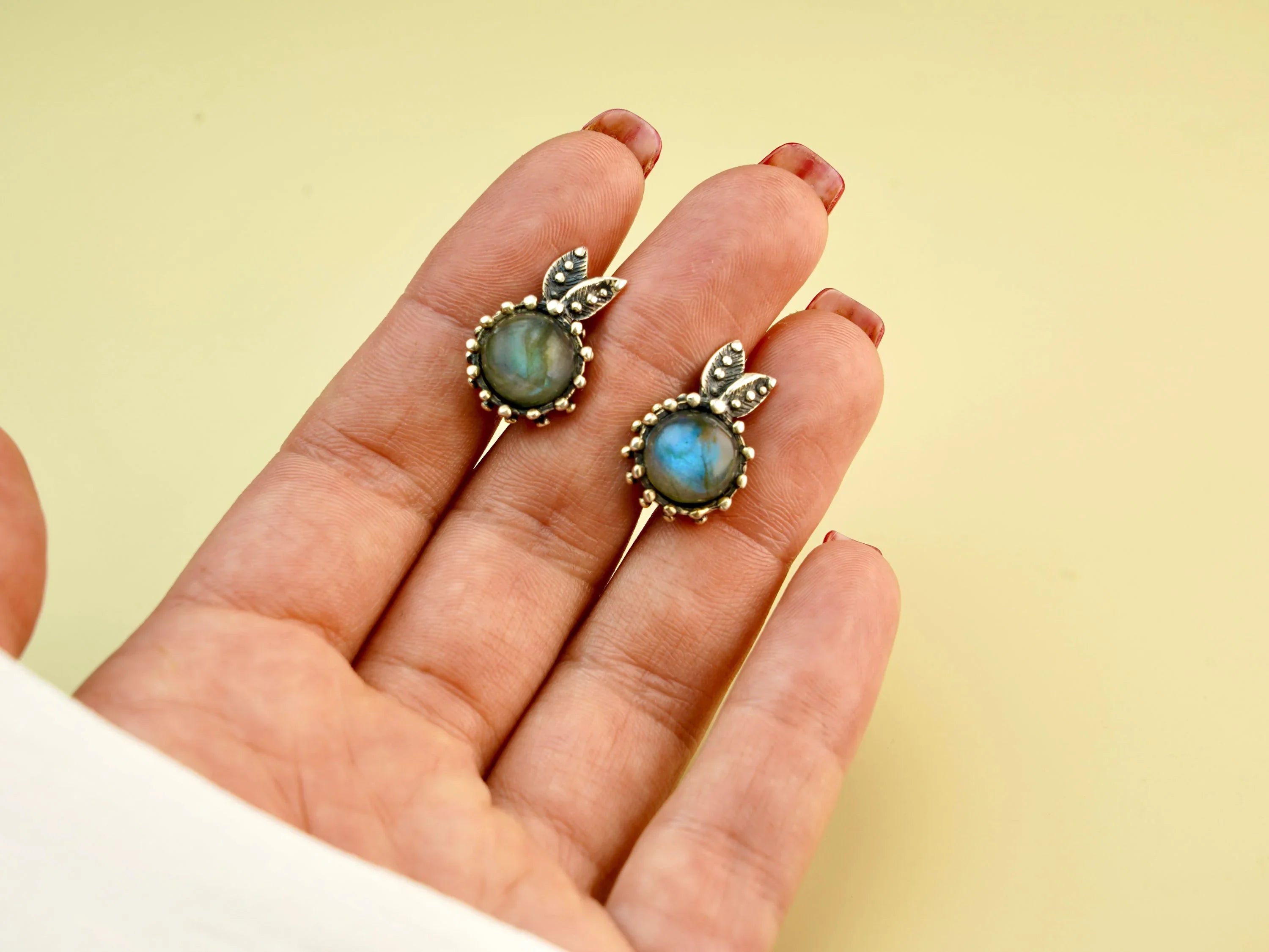 Handmade labradorite earrings worn on hand size reference blue flash gemstone jewelry