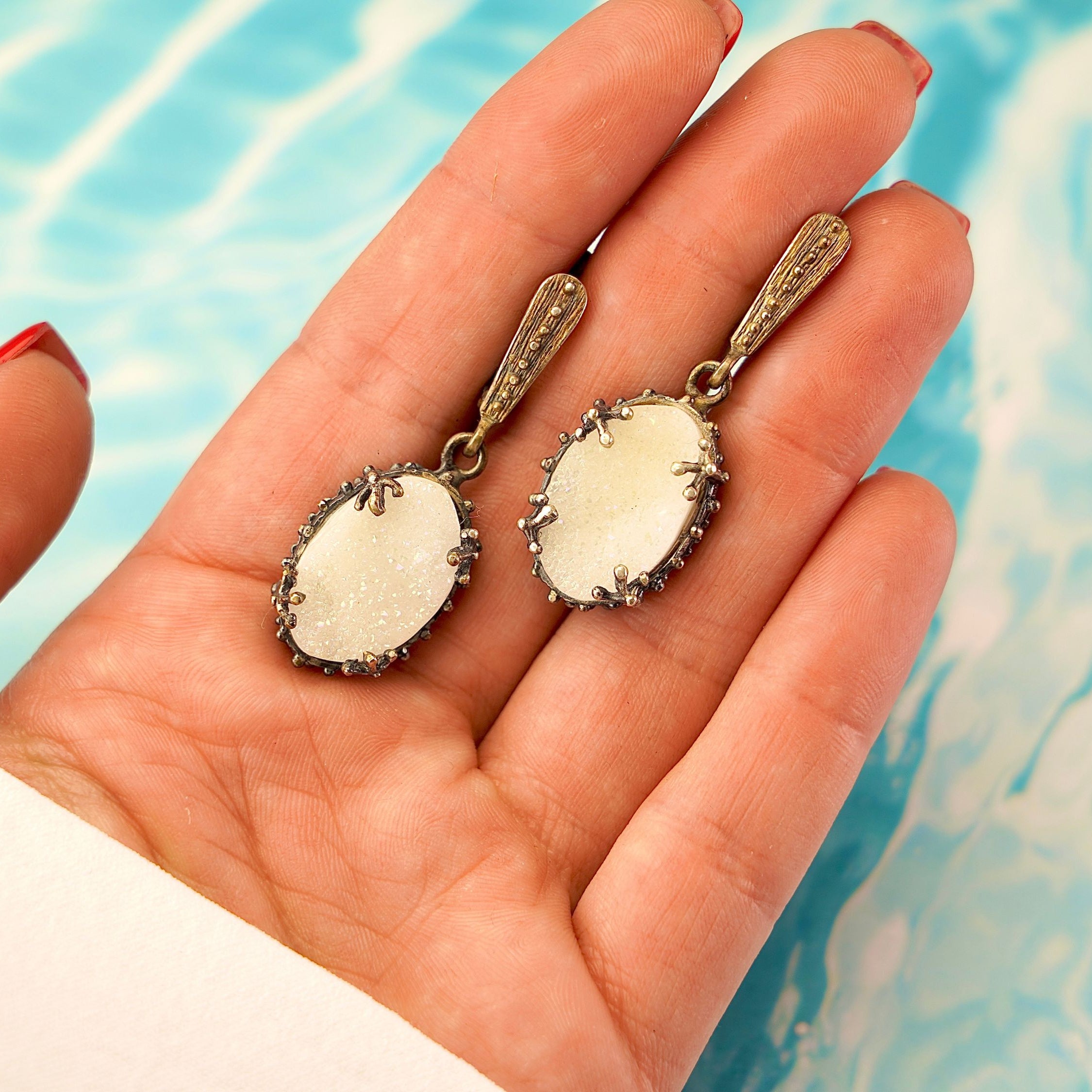 Moonstone drop earrings on hand size reference white gemstone silver earrings
