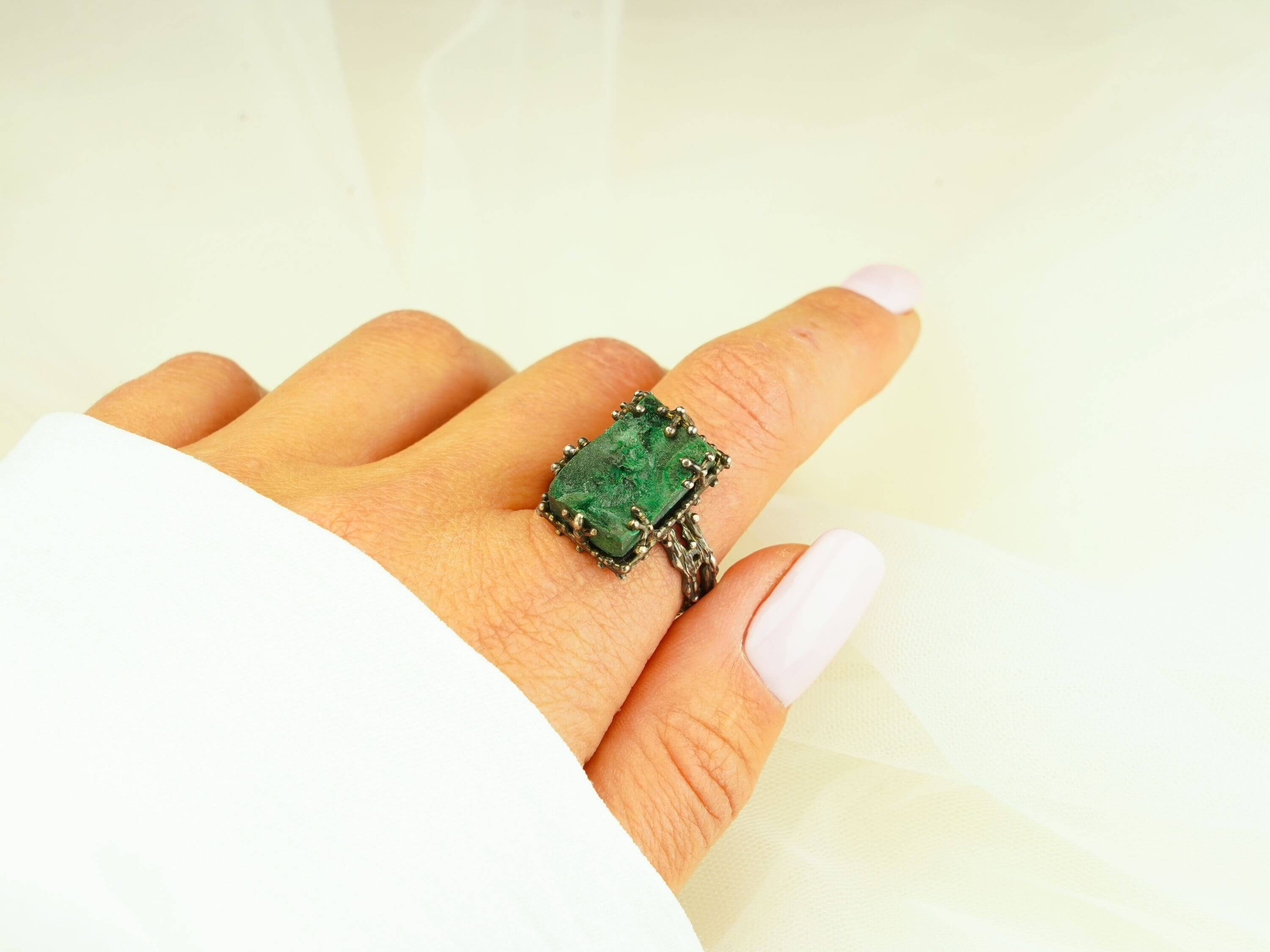 Statement raw malachite stone ring worn on finger showing large rectangular gemstone size