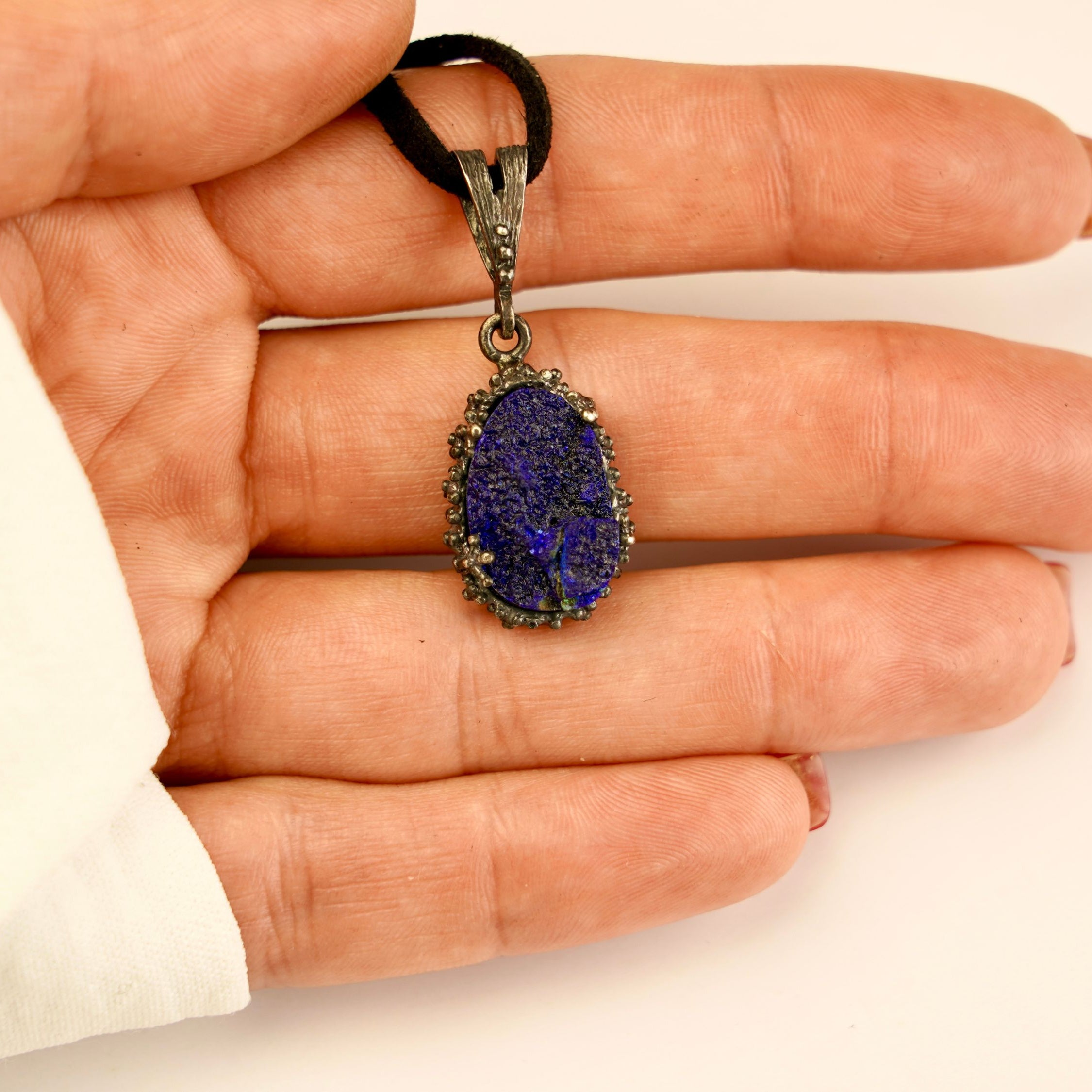 lapis lazuli pendant necklace on hand, size reference raw blue gemstone jewelry