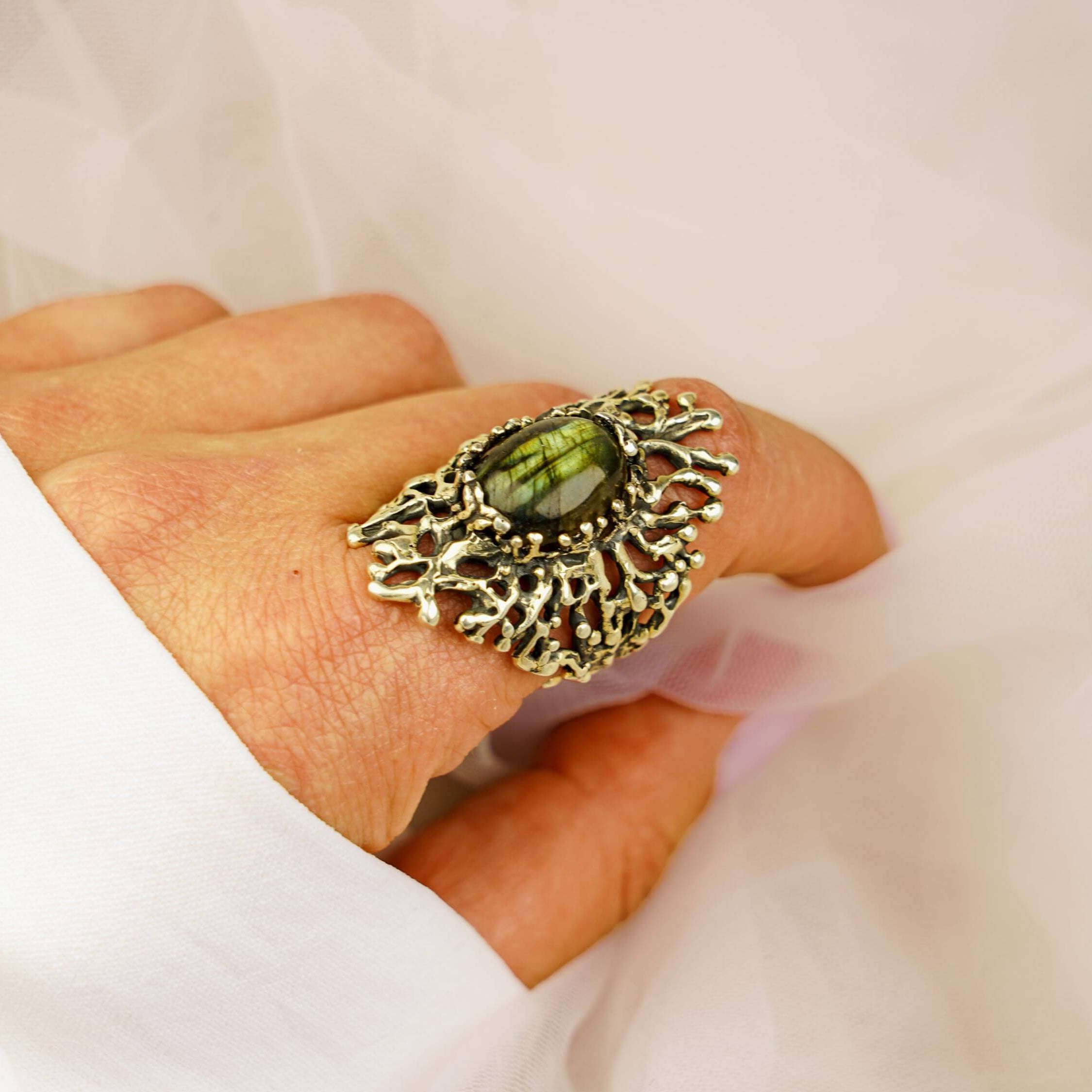 Statement gothic labradorite ring worn on hand showcasing the blue-green gemstone glow
