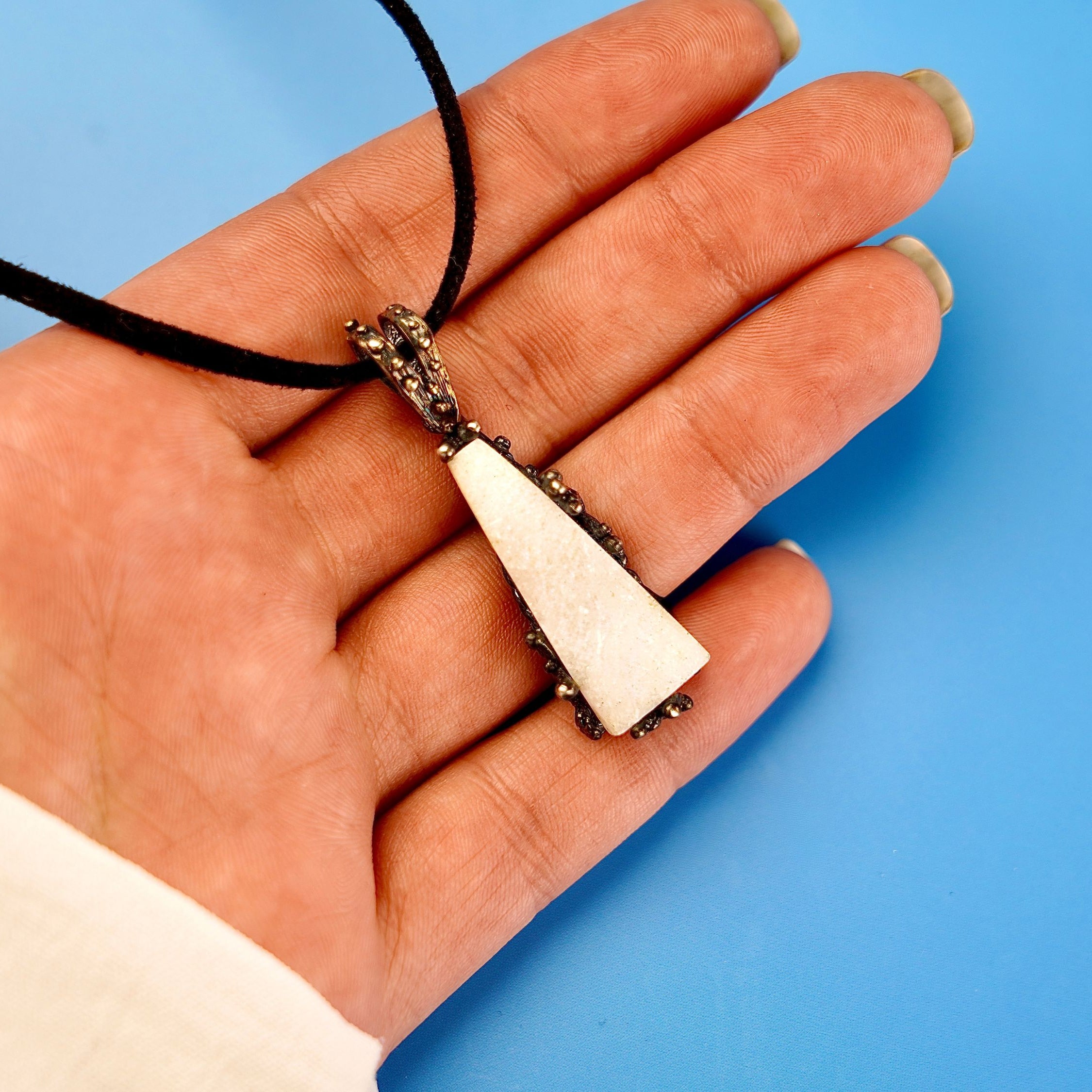 Moonstone pendant on hand size reference raw white gemstone silver necklace