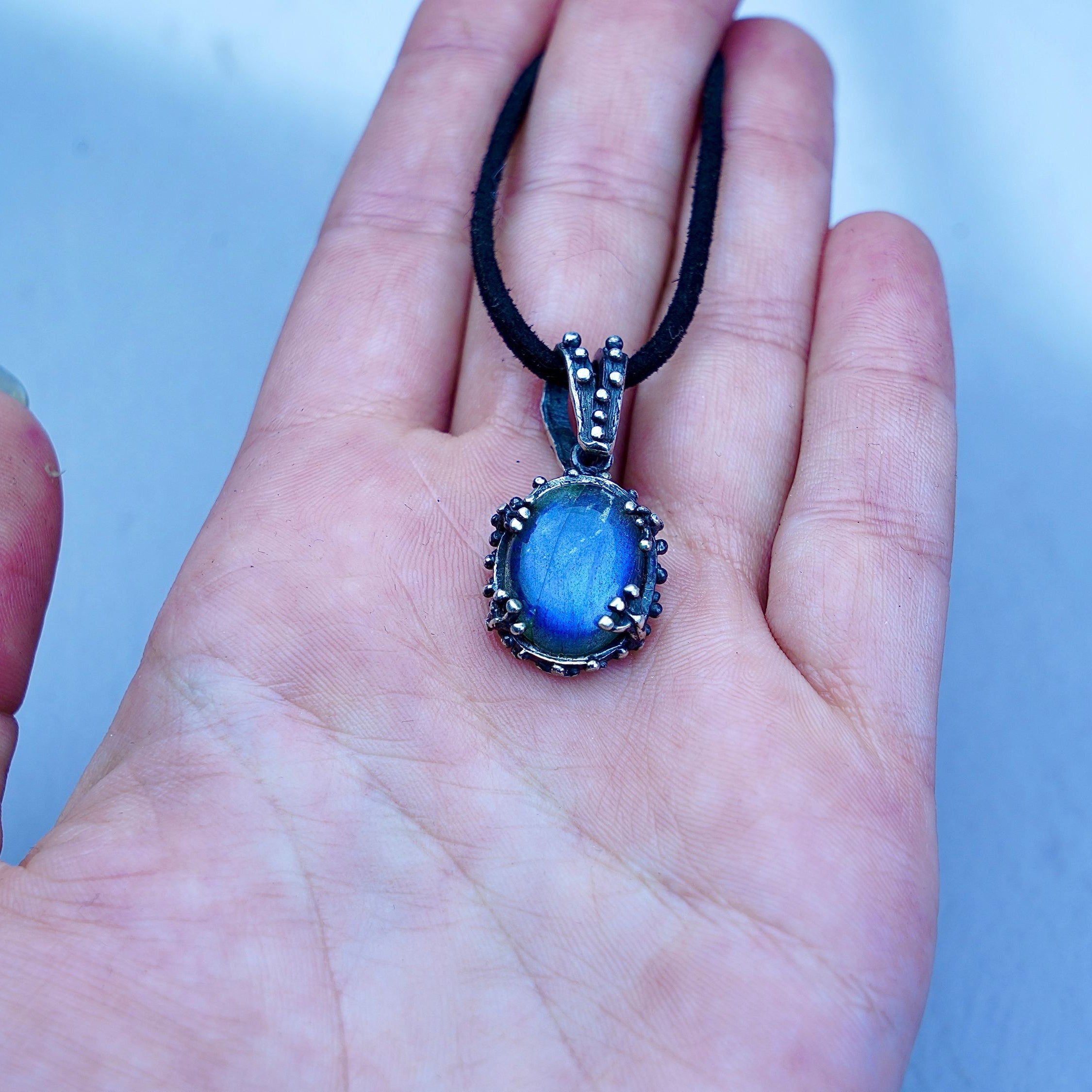 Labradorite pendant on hand size reference blue flash gemstone necklace