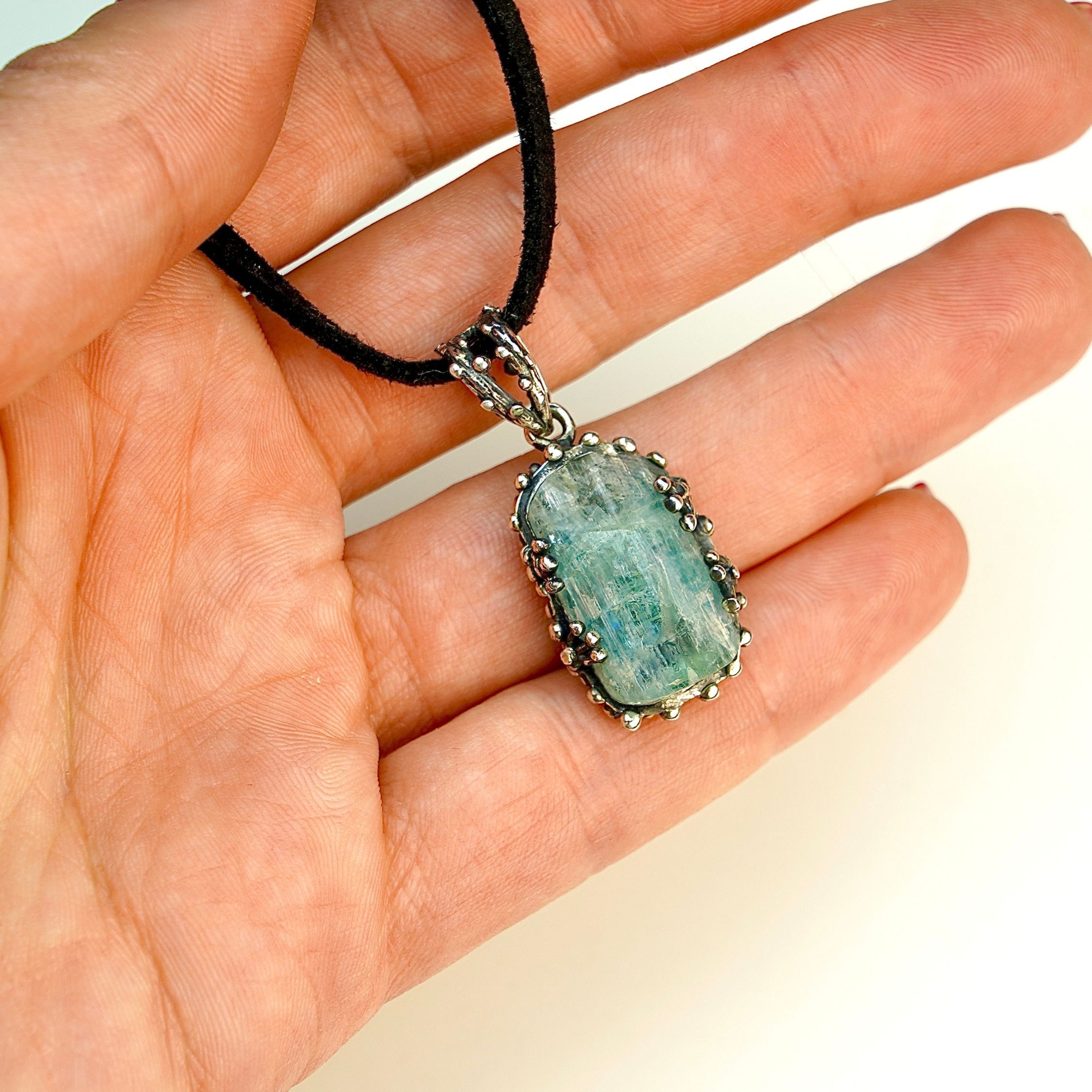 Aquamarine pendant on hand size reference raw blue gemstone silver necklace