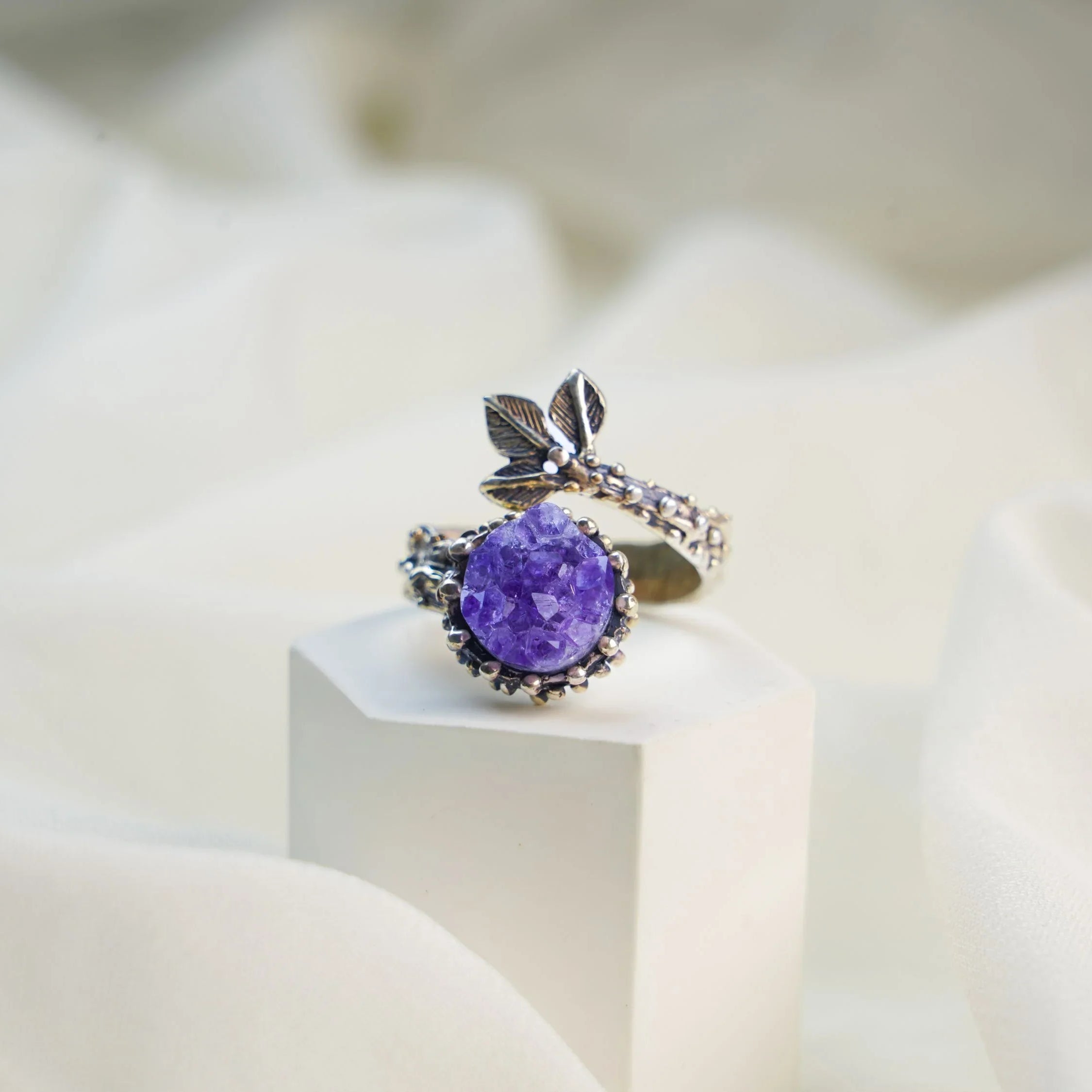 Amethyst ring on display minimalist jewelry aesthetic purple gemstone