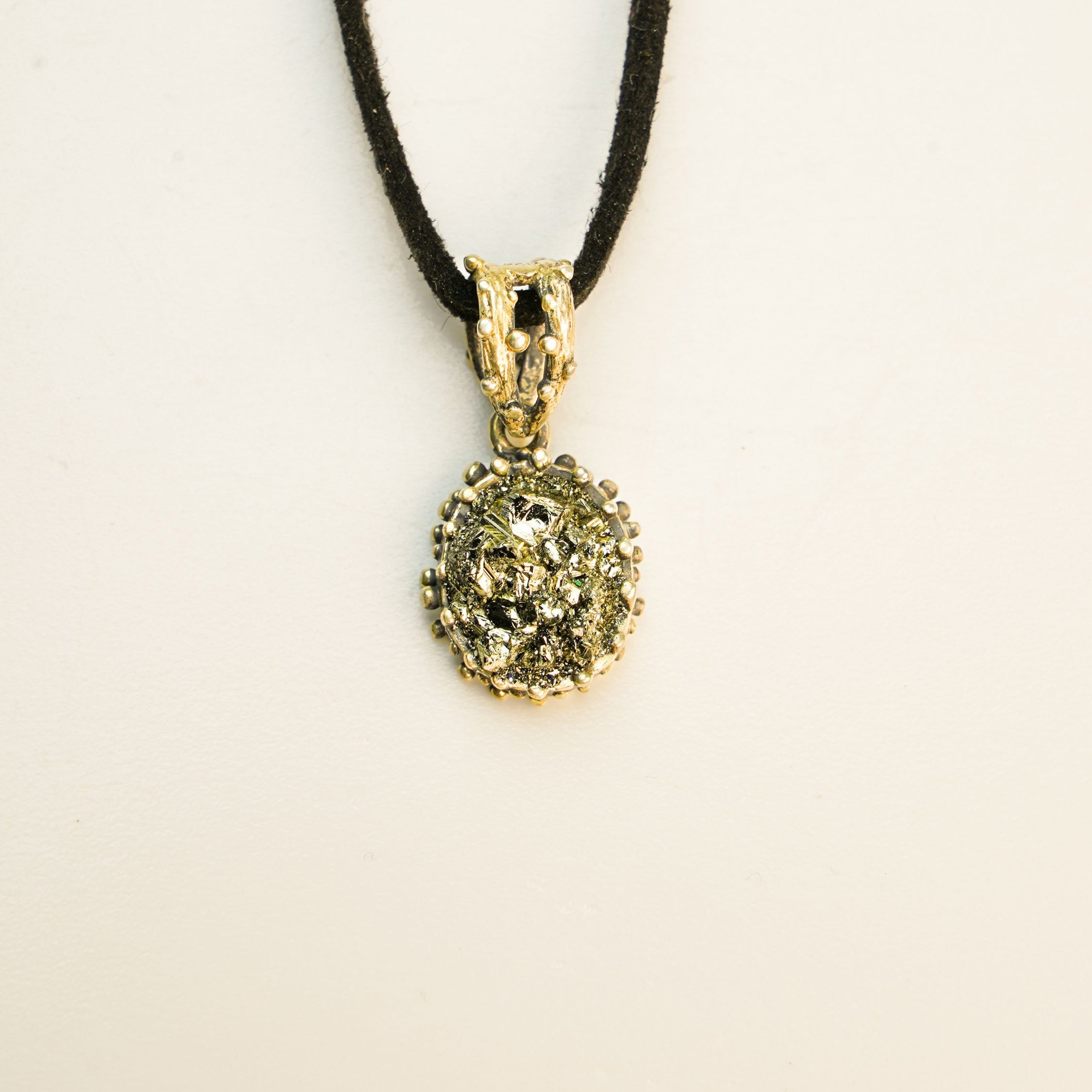 close up pyrite pendant natural gold crystal texture detail
