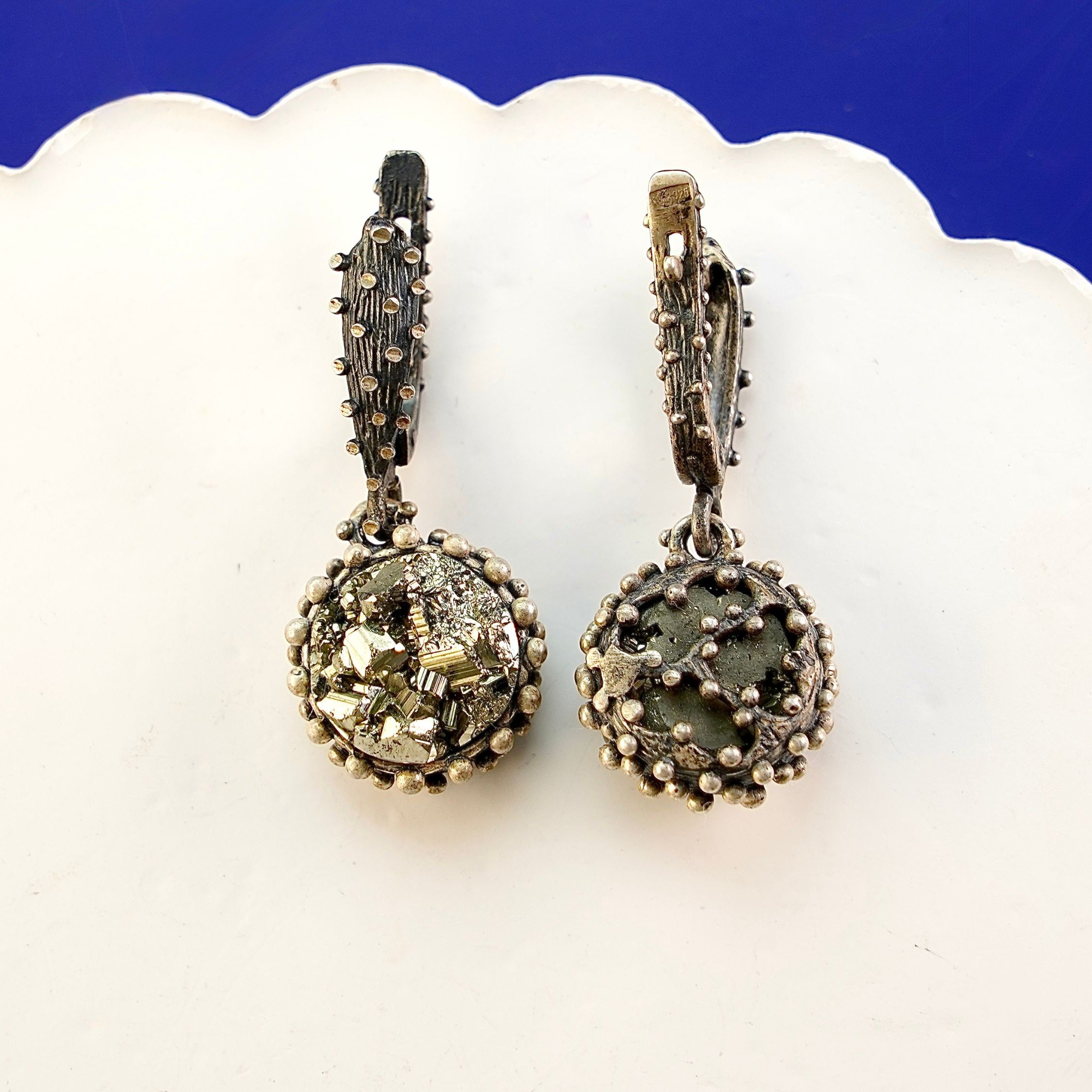 Close up pyrite earrings metallic gold crystal cluster detail silver setting