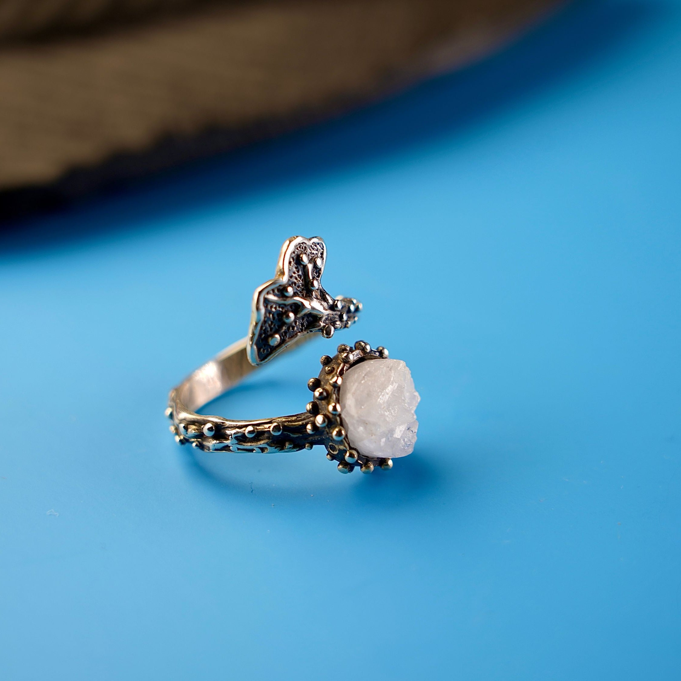 Close up moonstone smooth surface soft glow crystal detail adjustable sterling silver ring