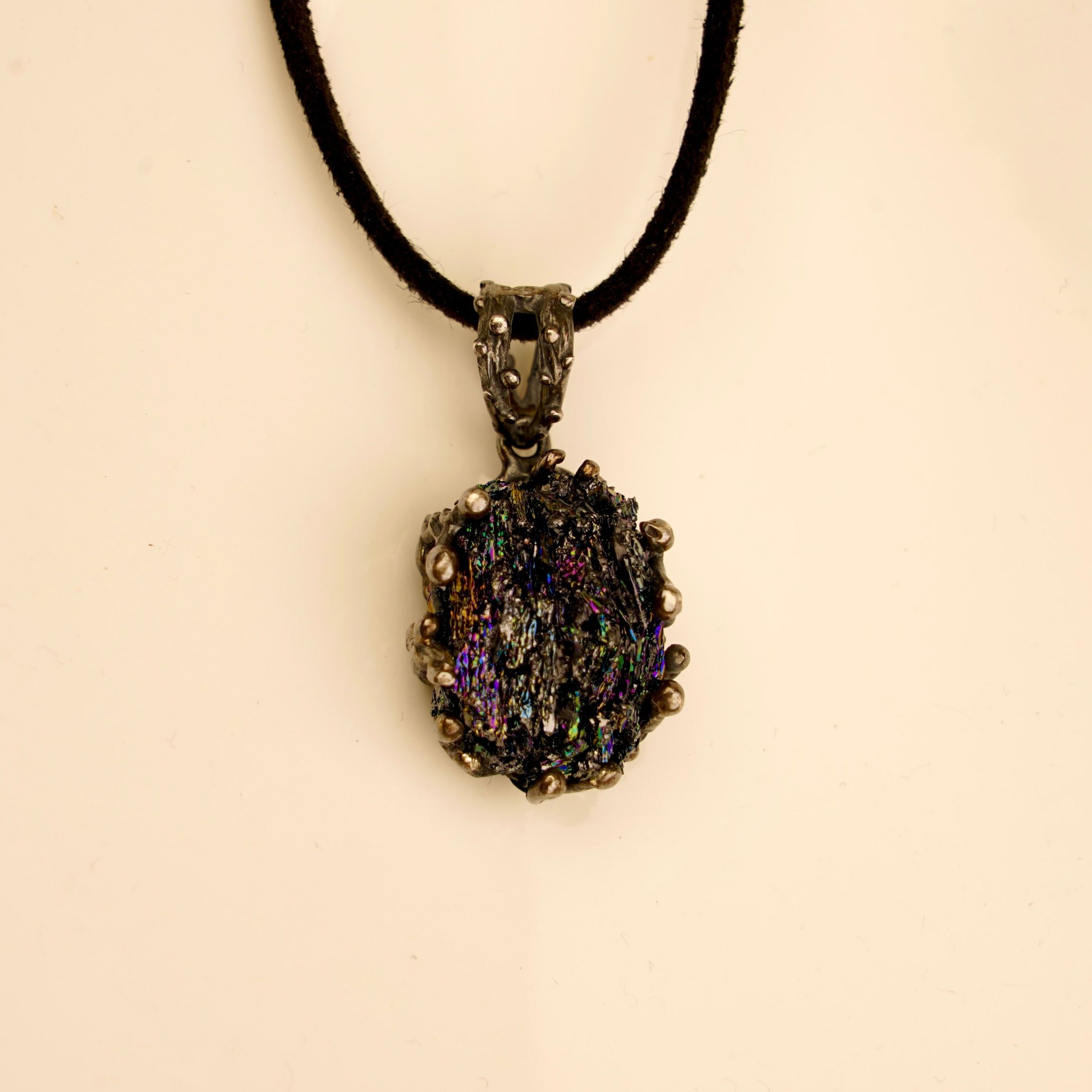 Front view of a gothic-style Obsidian necklace with a dark silver setting and an adjustable black cord