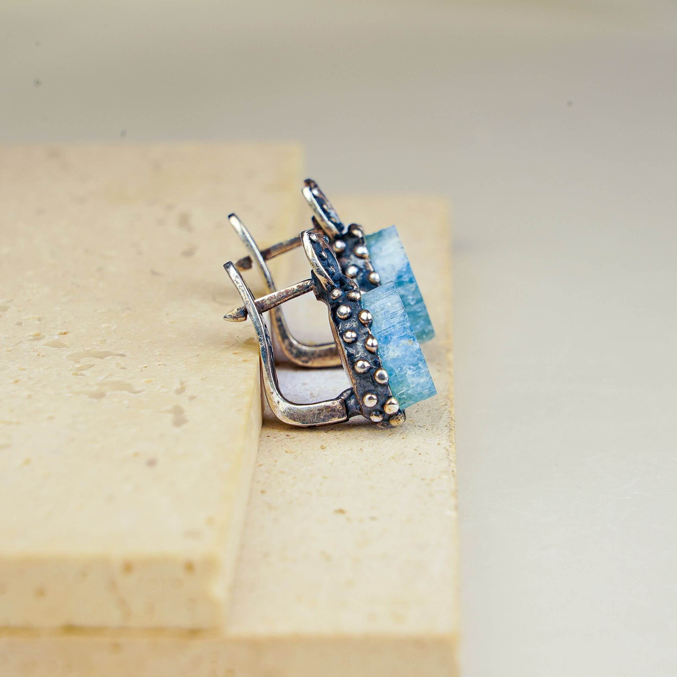 Macro shot of natural raw-cut aquamarine stones highlighting the unique crystalline texture