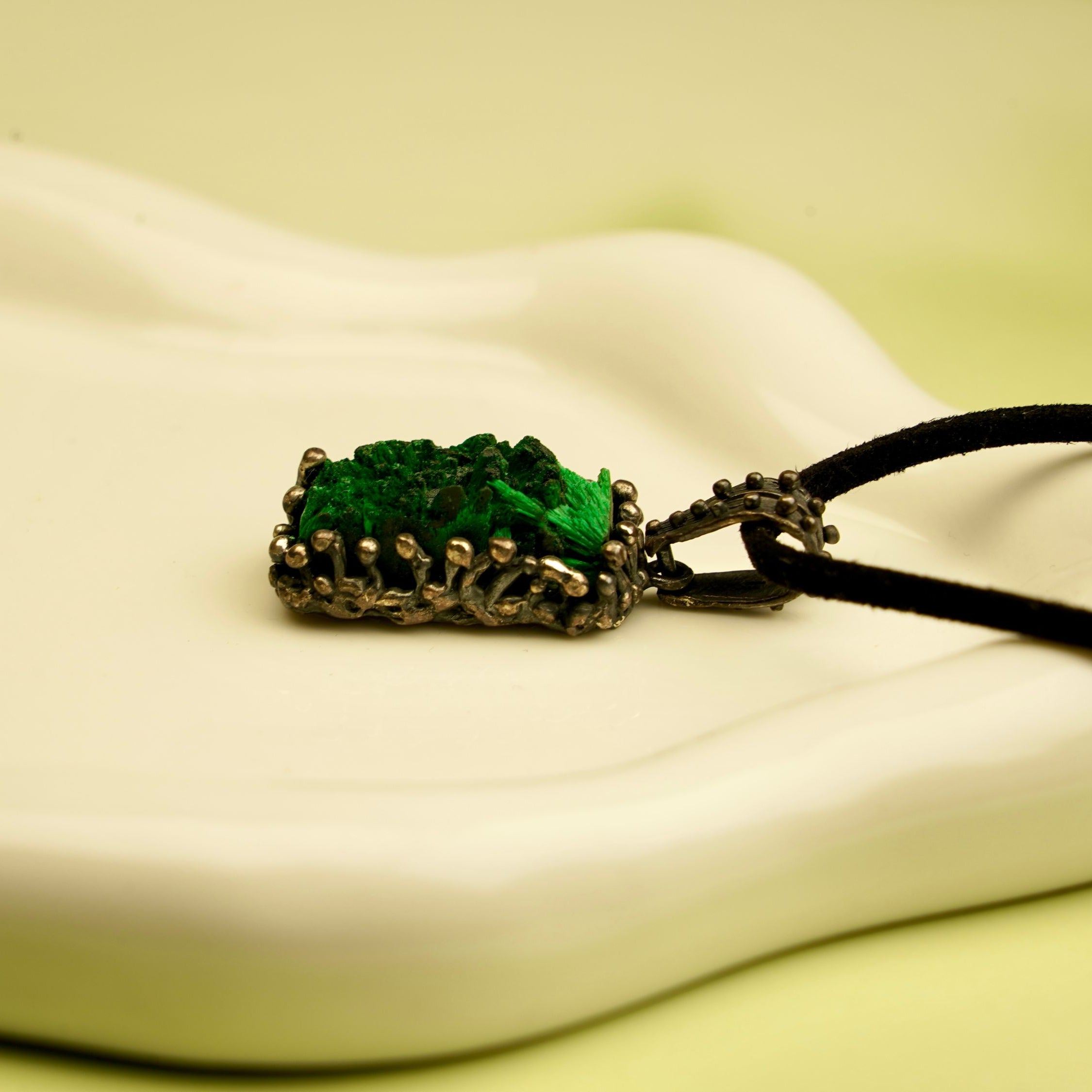 close up malachite crystal pendant natural green stone texture detail