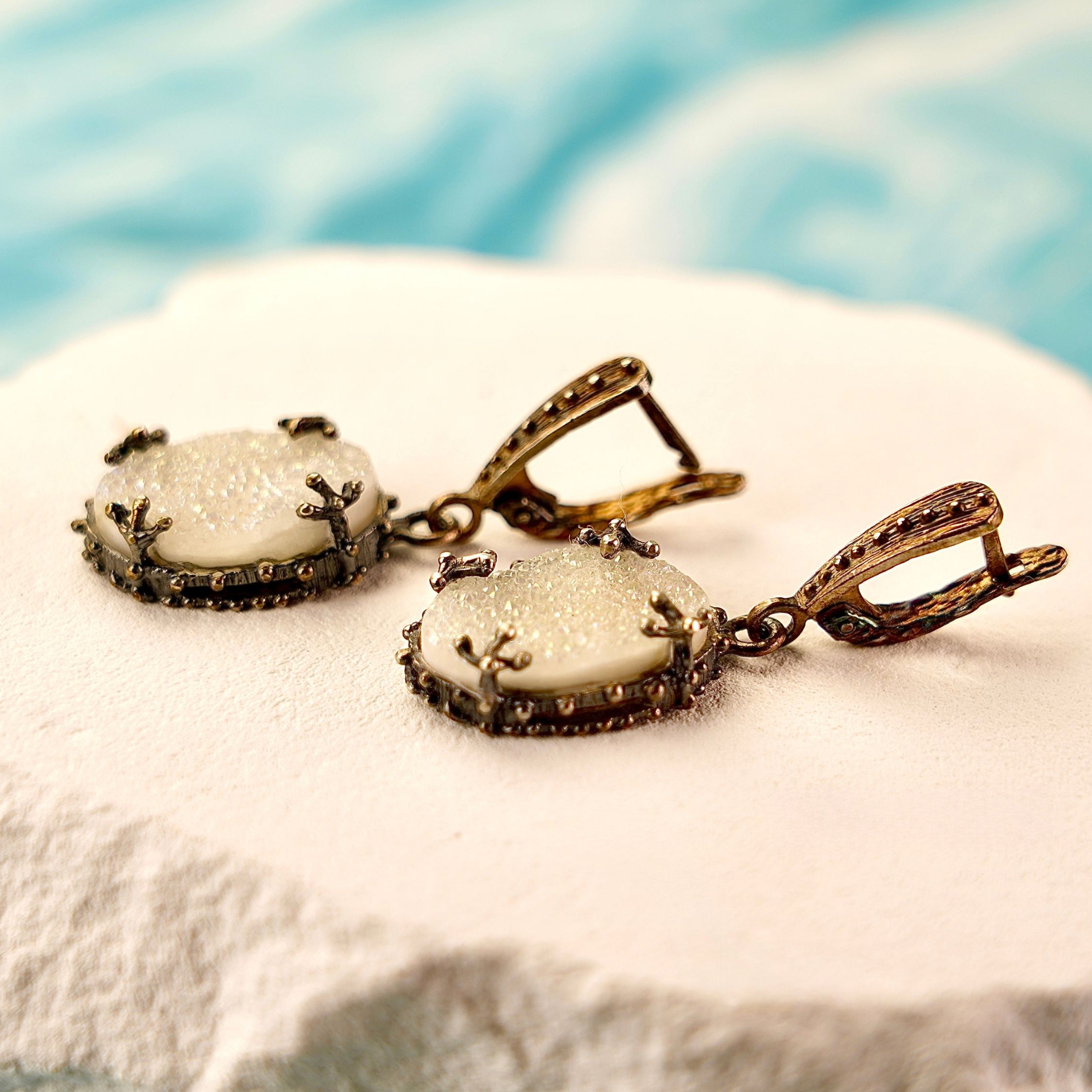 Close up moonstone drop earrings glowing white stone detail silver setting