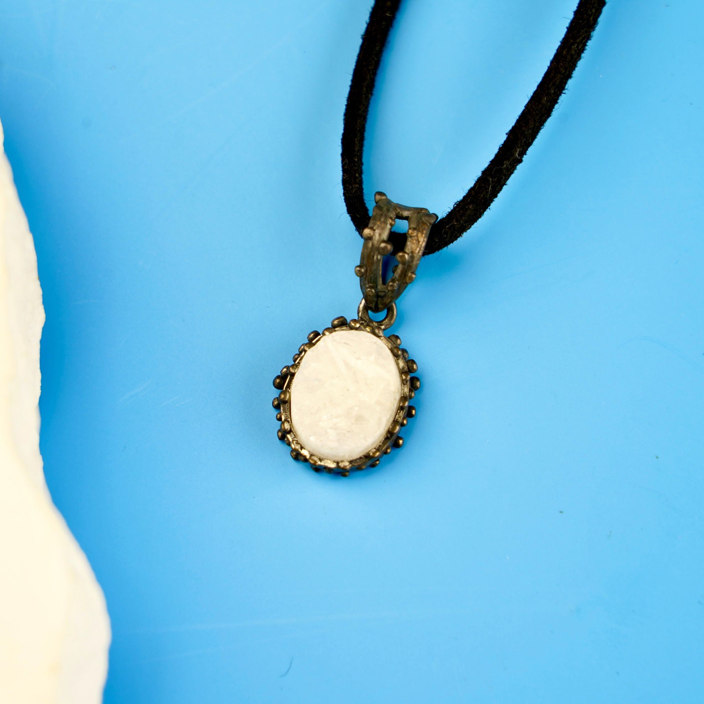 close up moonstone pendant, natural white gemstone soft glow detail