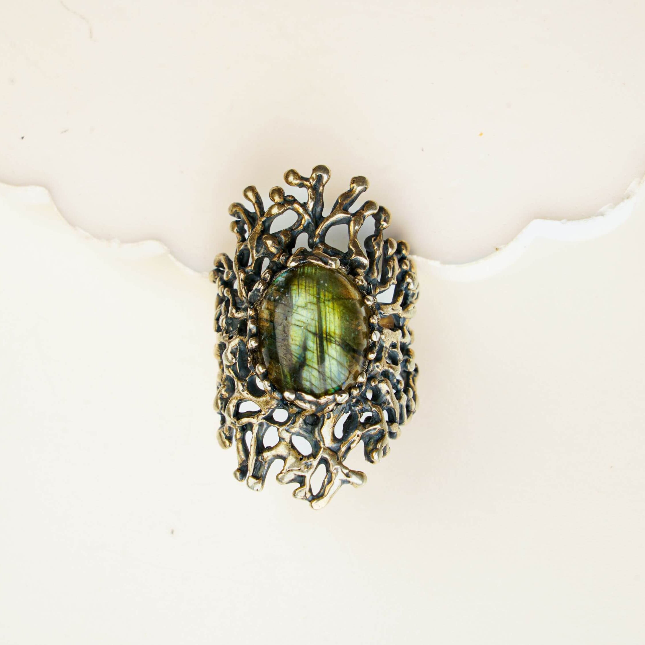Macro view of a natural iridescent labradorite stone in a detailed vintage silver frame
