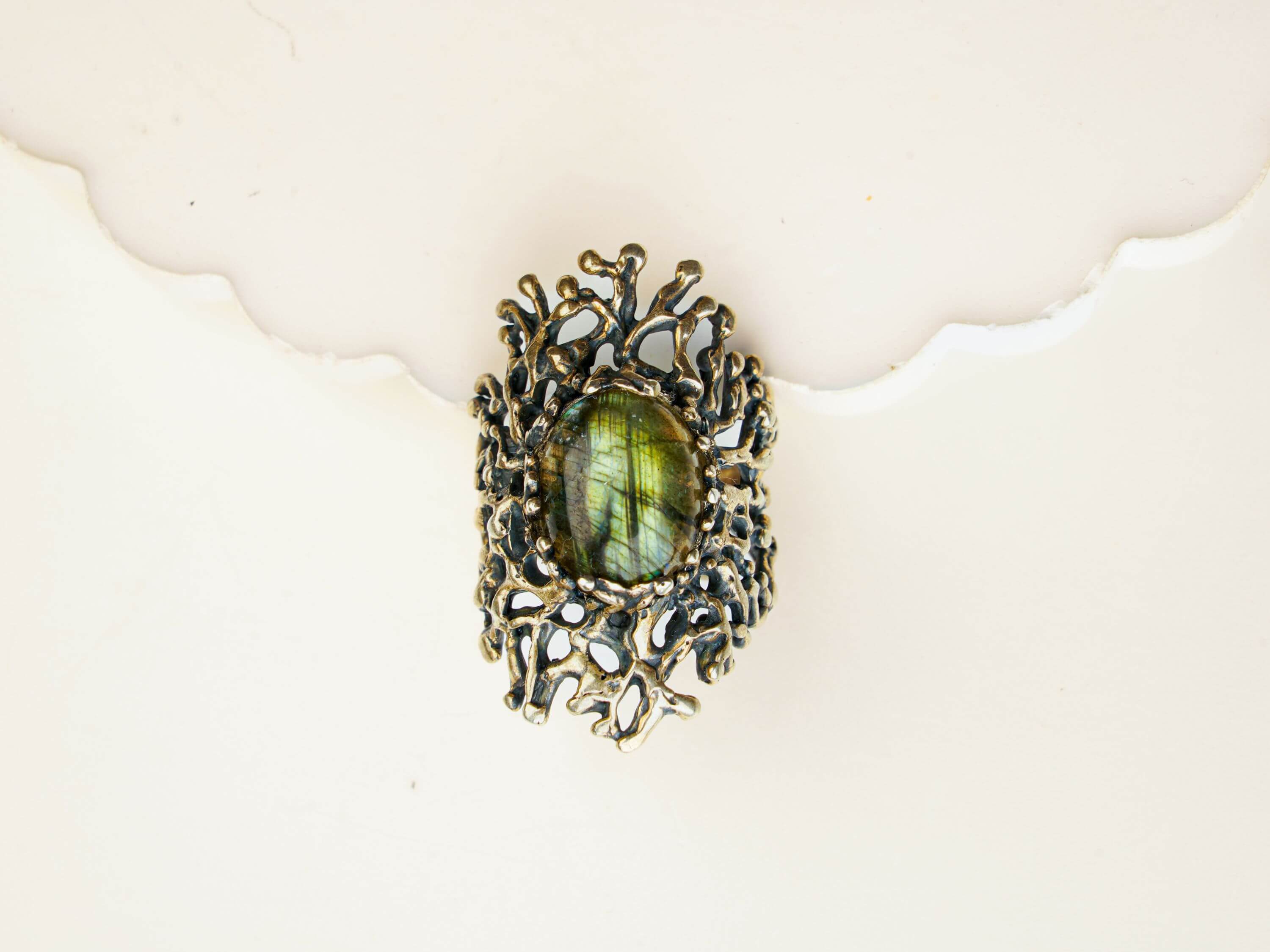 Macro view of a natural iridescent labradorite stone in a detailed vintage silver frame