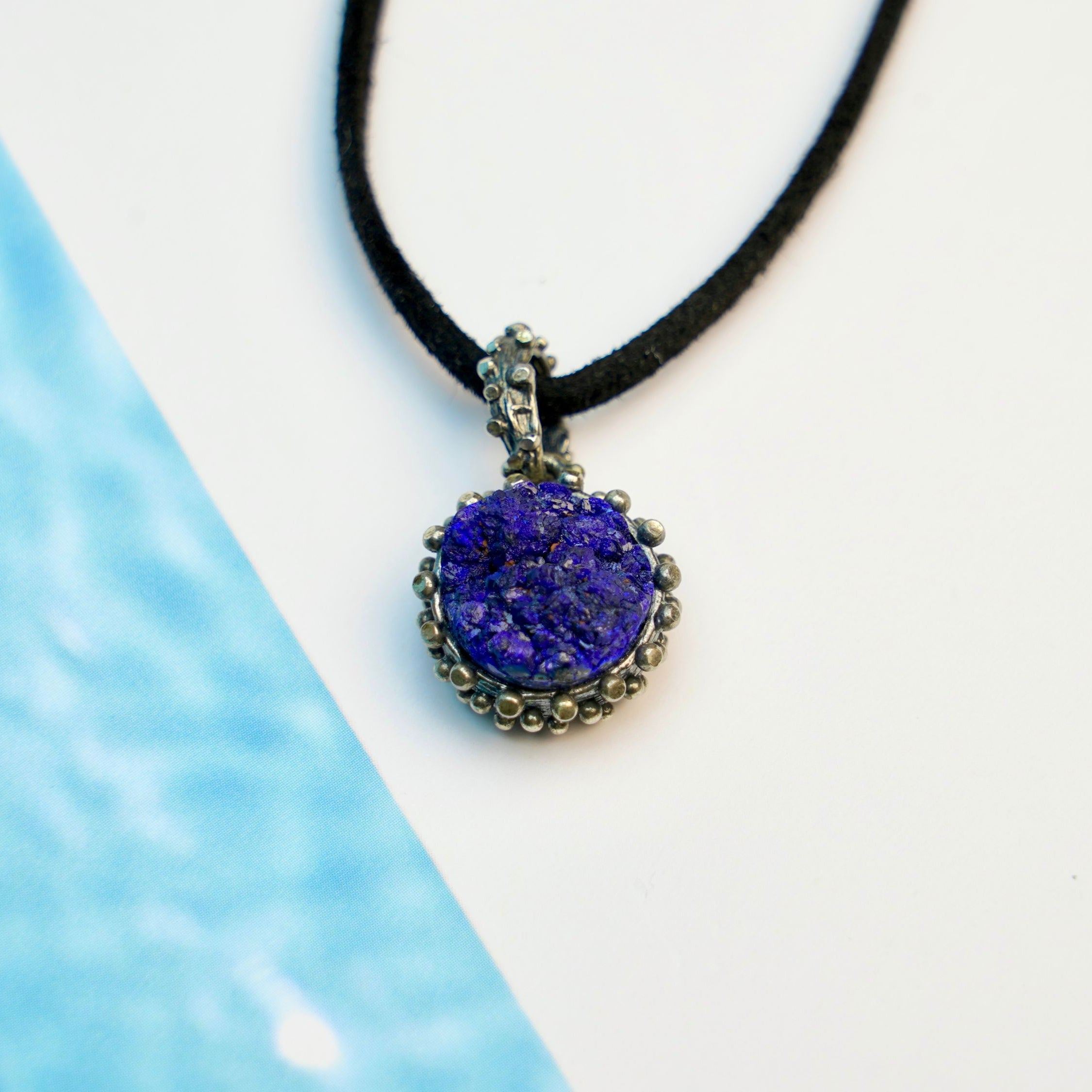 close up lapis lazuli pendant, smooth blue gemstone refined detail