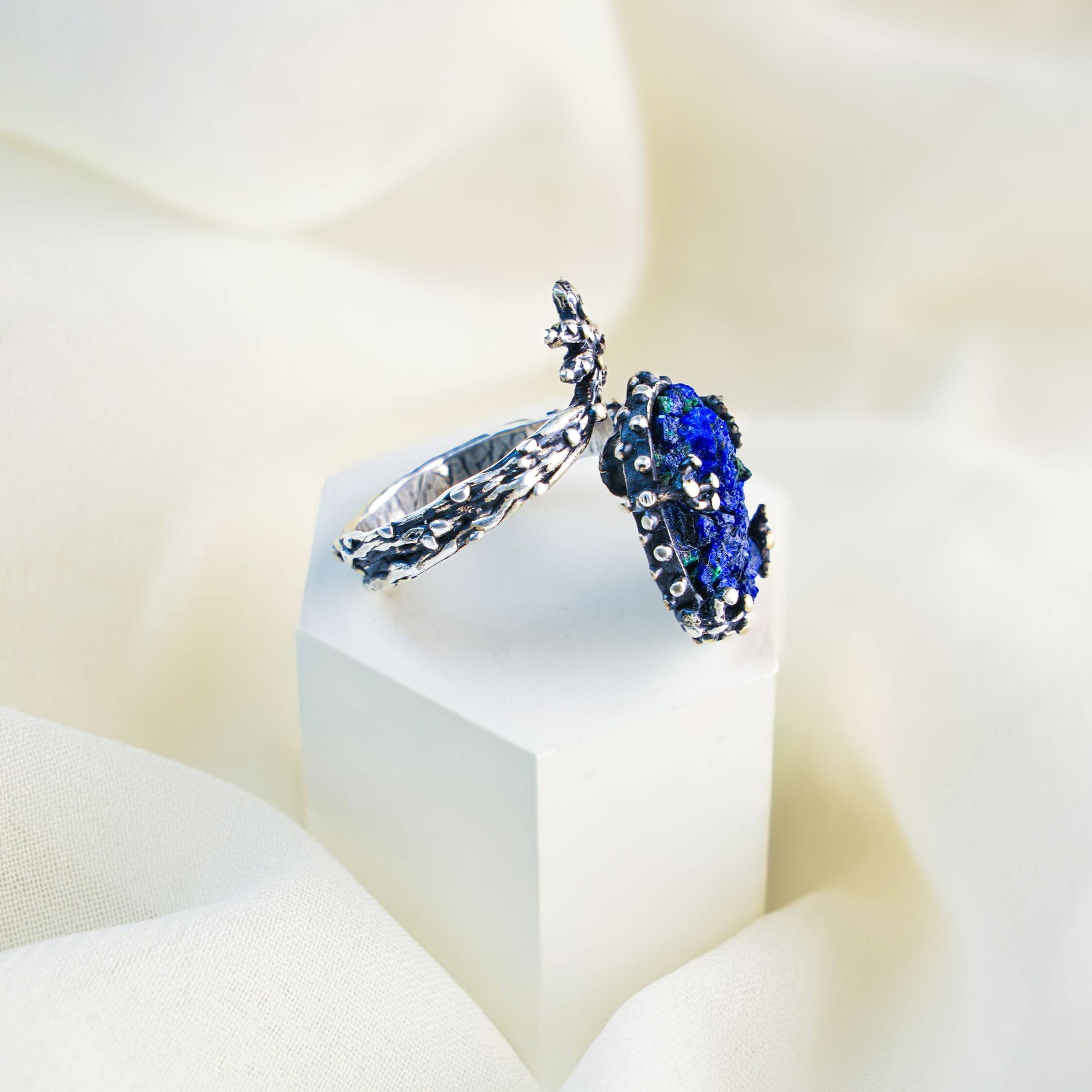 Side view of the twig style lapis lazuli ring showcasing the organic silver branch craftsmanship