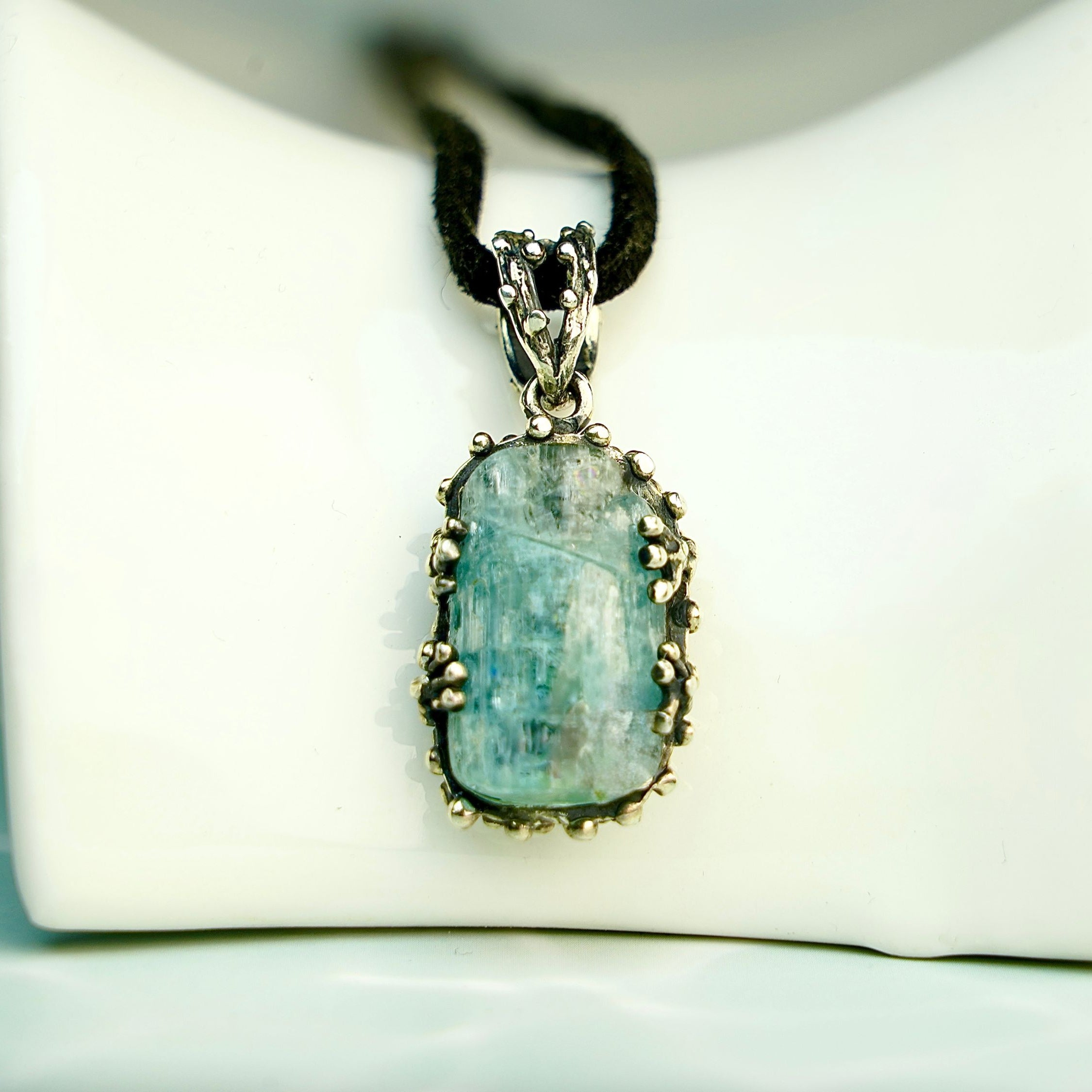 Clean front view aquamarine necklace raw blue crystal silver pendant minimal composition