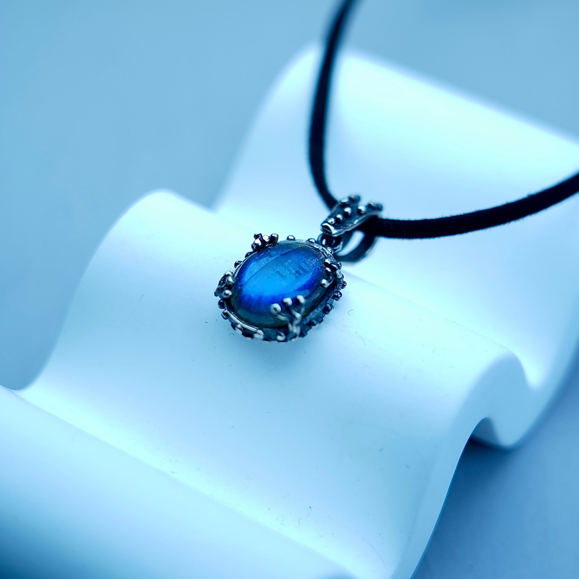 Labradorite necklace clean front view blue flash pendant minimal composition