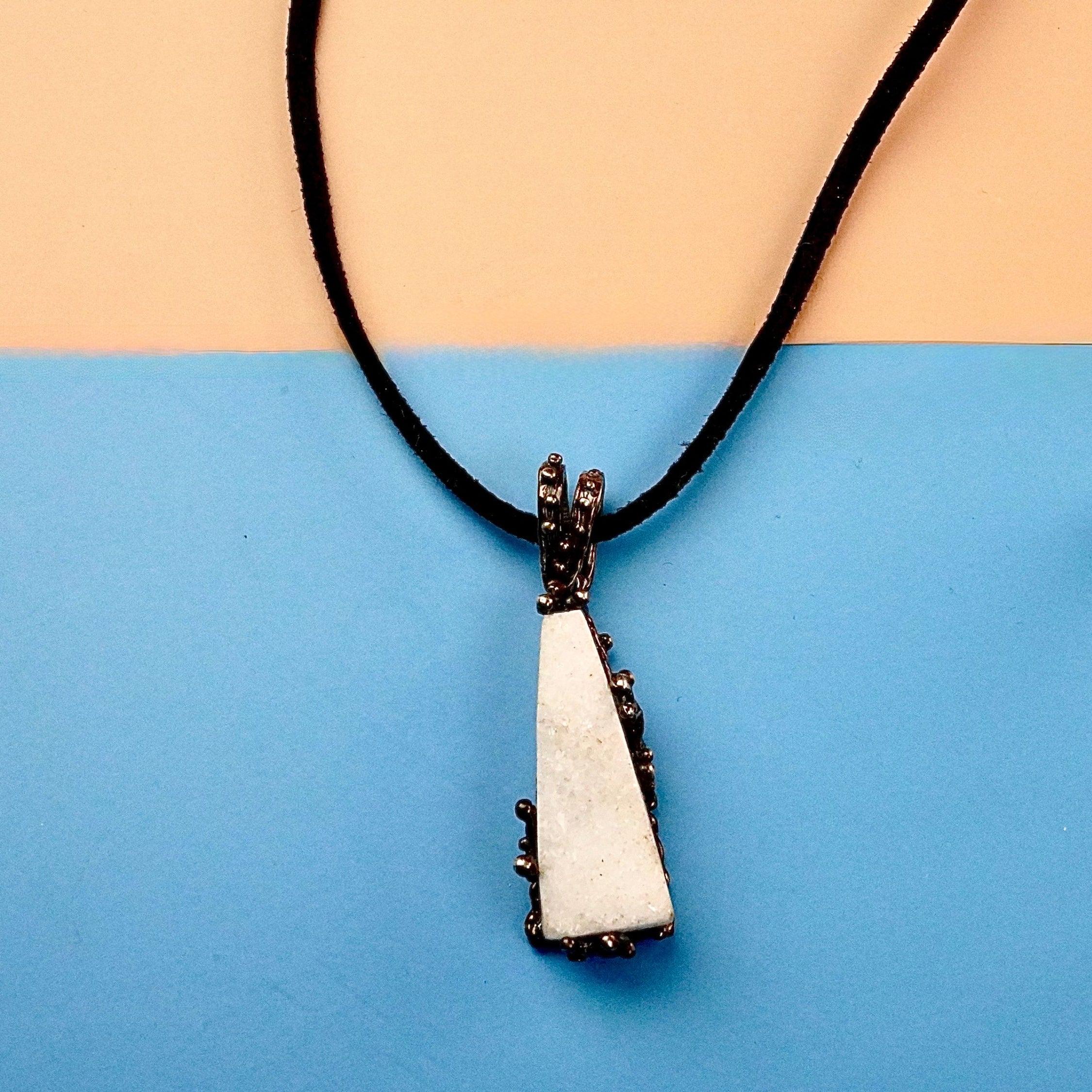 Clean front view moonstone necklace raw white crystal silver pendant minimal composition