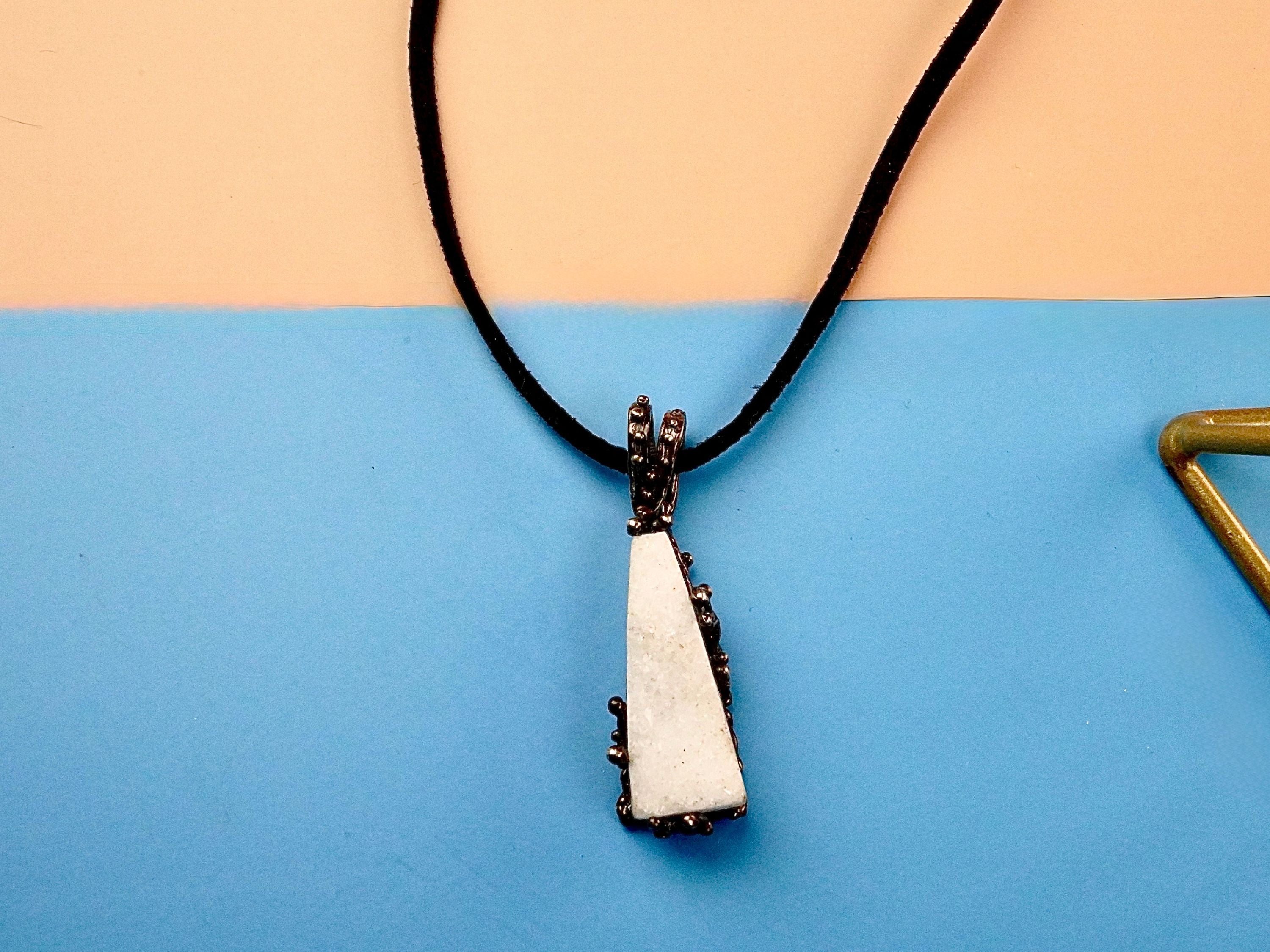 Clean front view moonstone necklace raw white crystal silver pendant minimal composition
