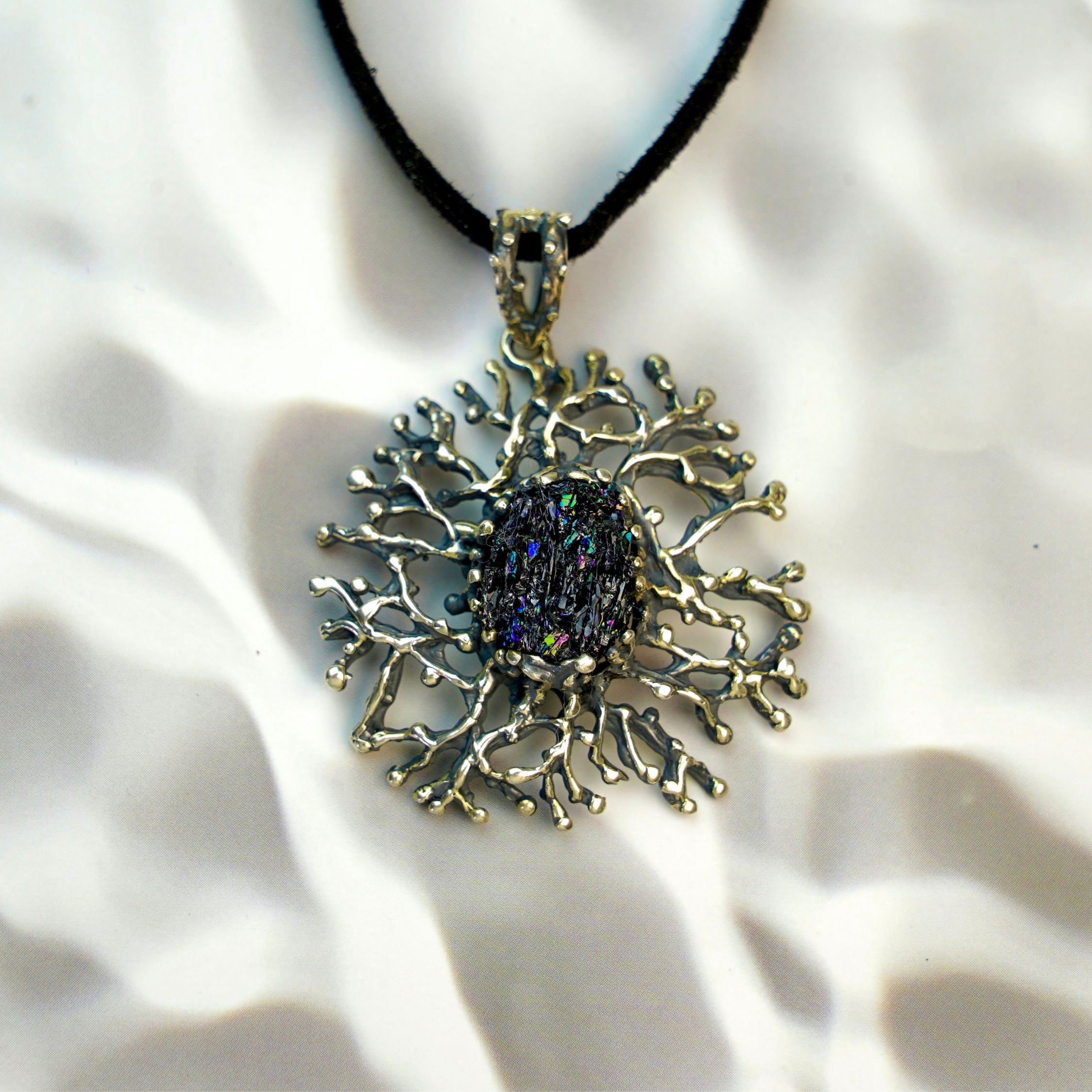 tourmaline pendant necklace front view, intricate silver design with raw crystal