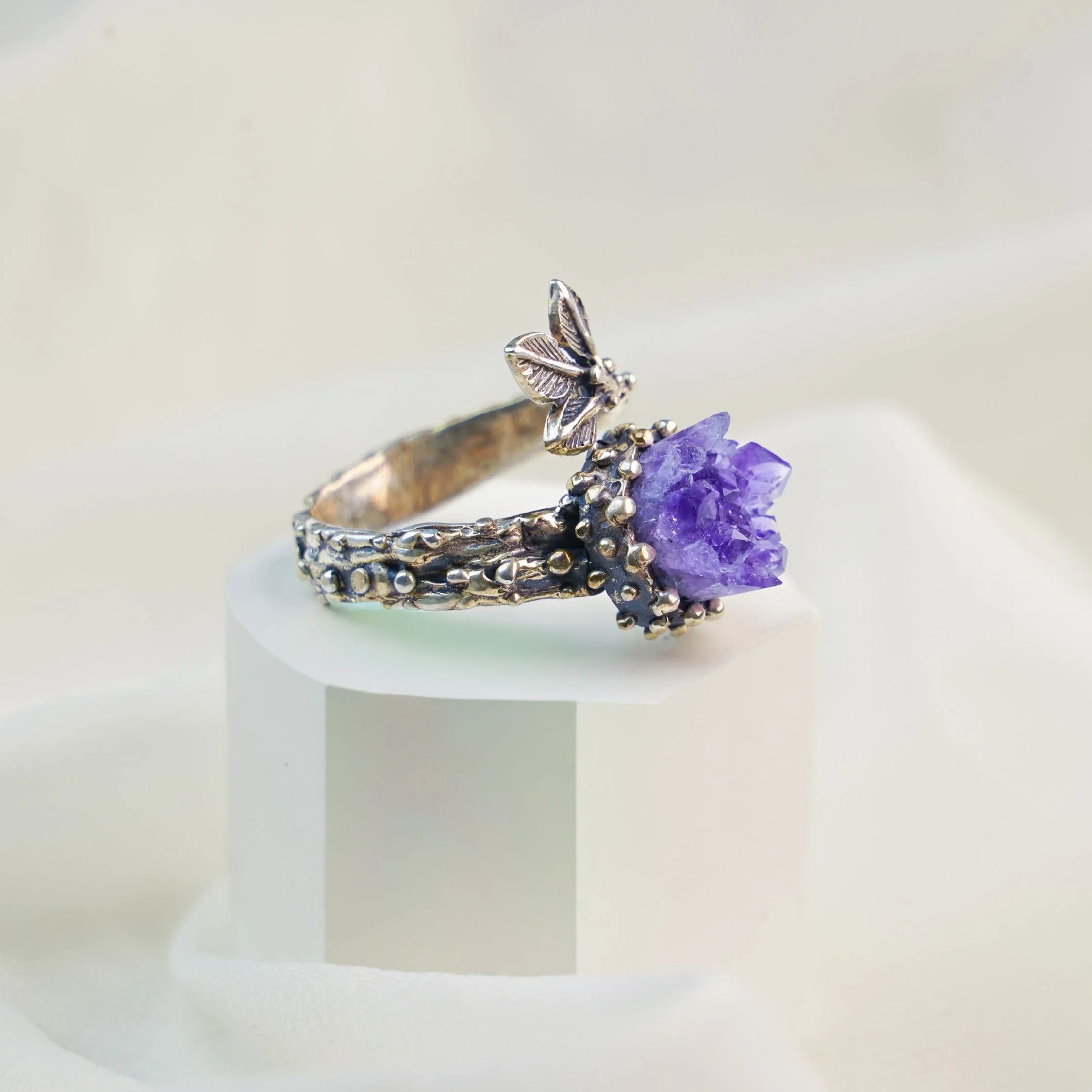 Amethyst ring angled view purple gemstone adjustable sterling silver band