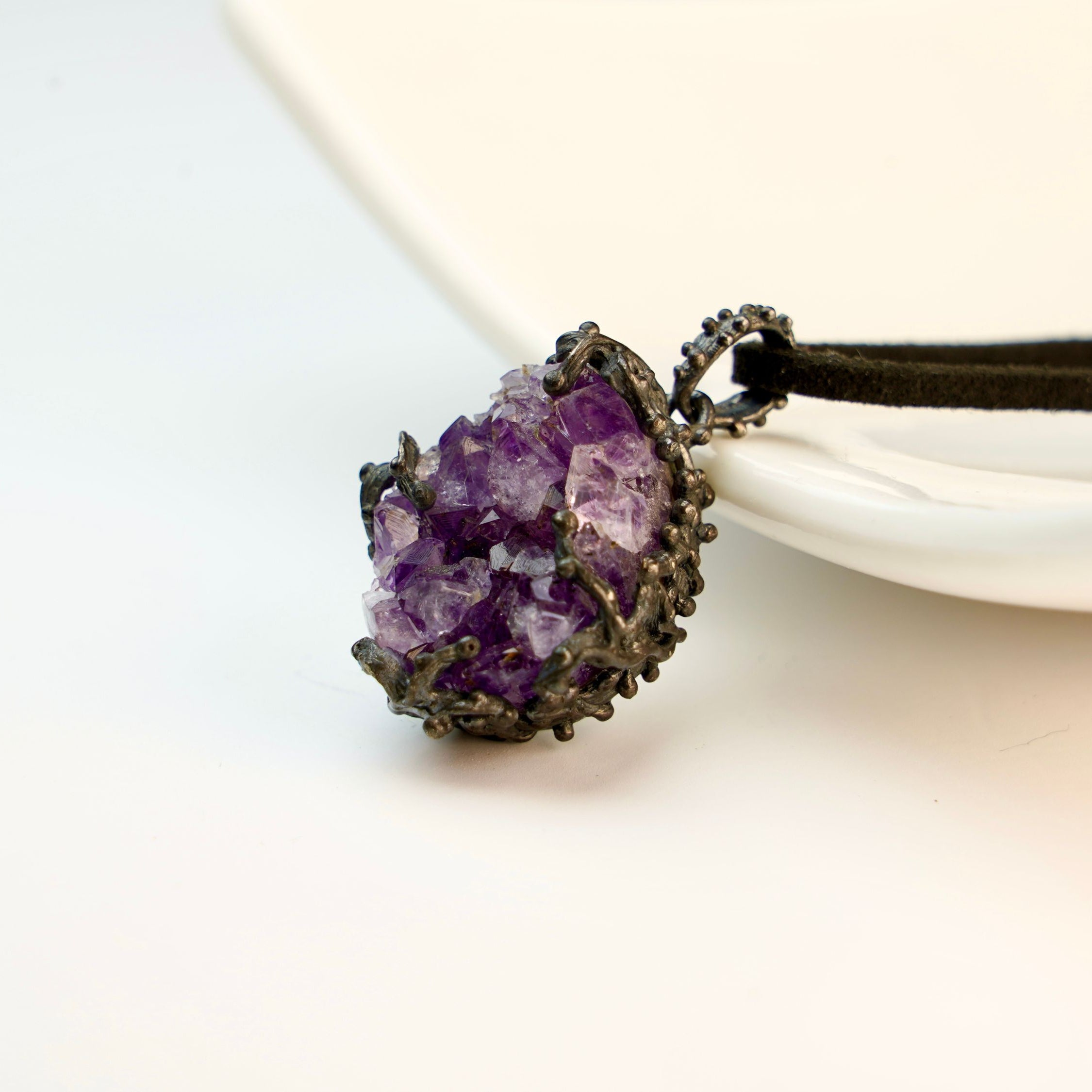 amethyst crystal pendant angled view, purple gemstone jewelry aesthetic