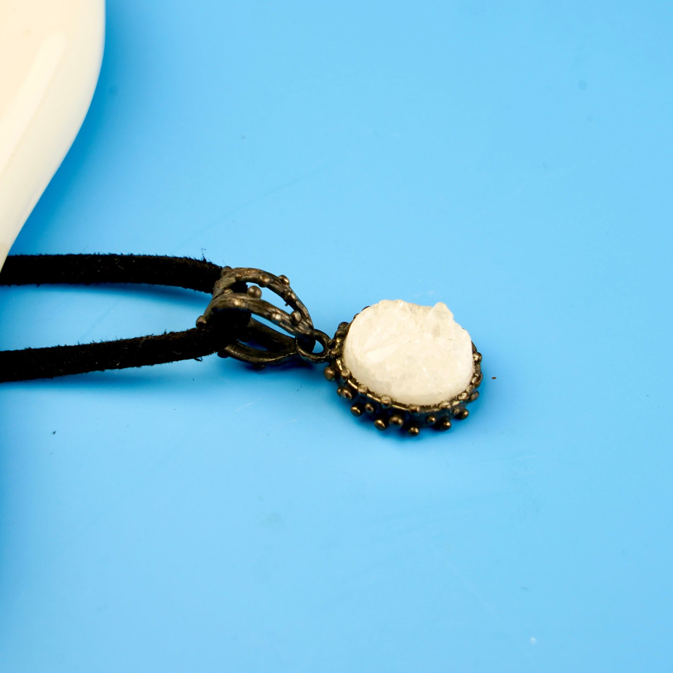moonstone pendant angled view, white gemstone elegant jewelry aesthetic