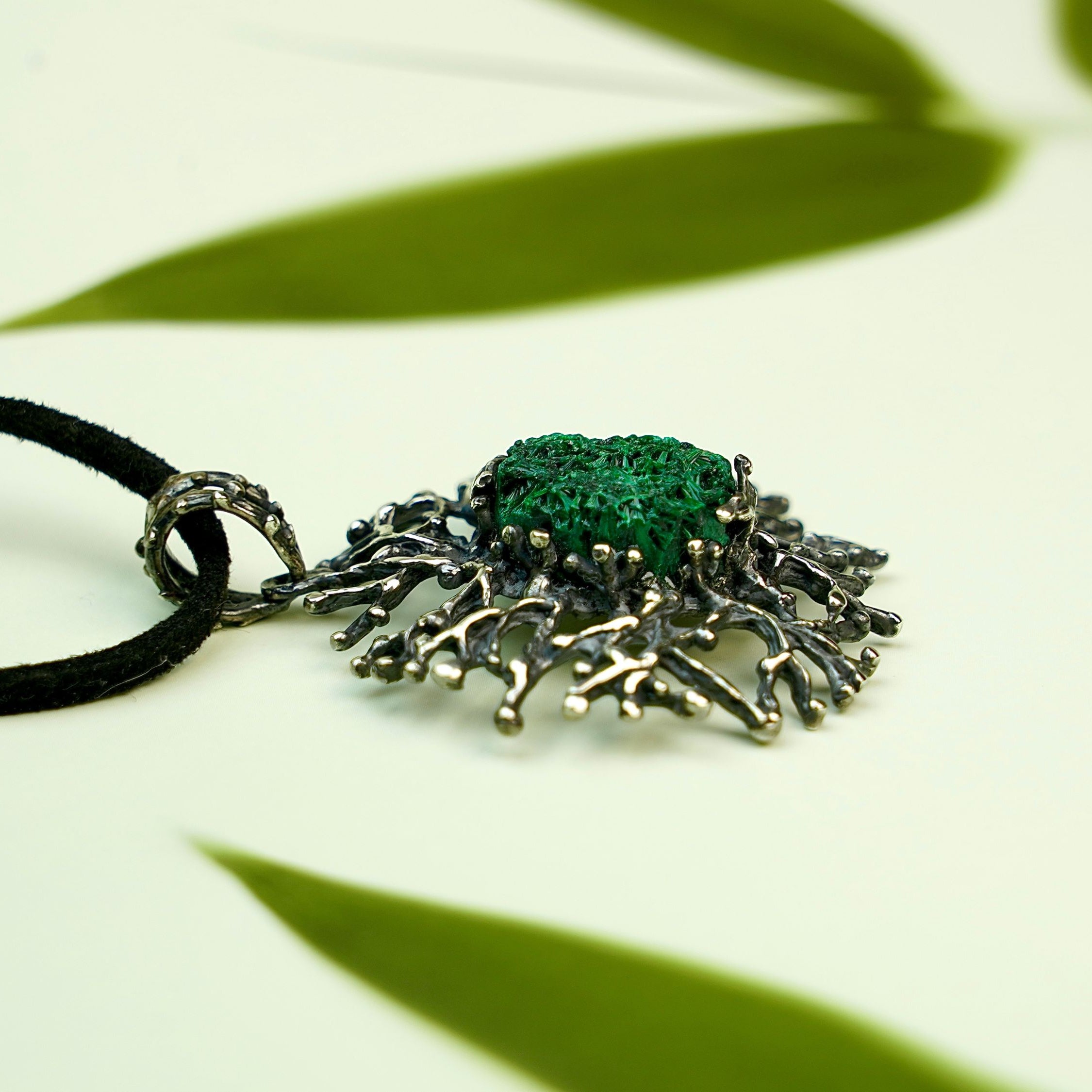 Malachite necklace angle view green gemstone pendant elegant silver jewelry