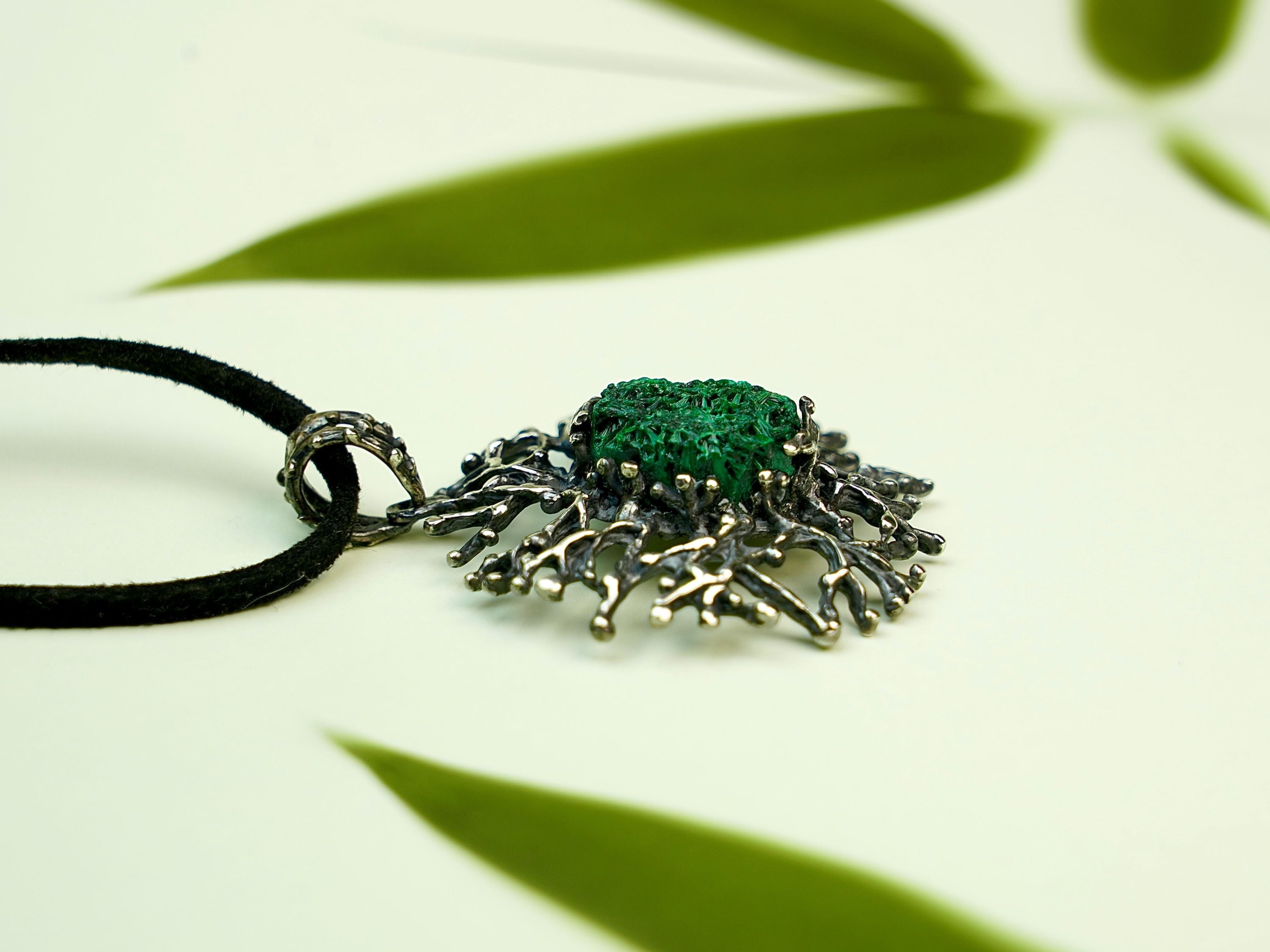 Malachite necklace angle view green gemstone pendant elegant silver jewelry