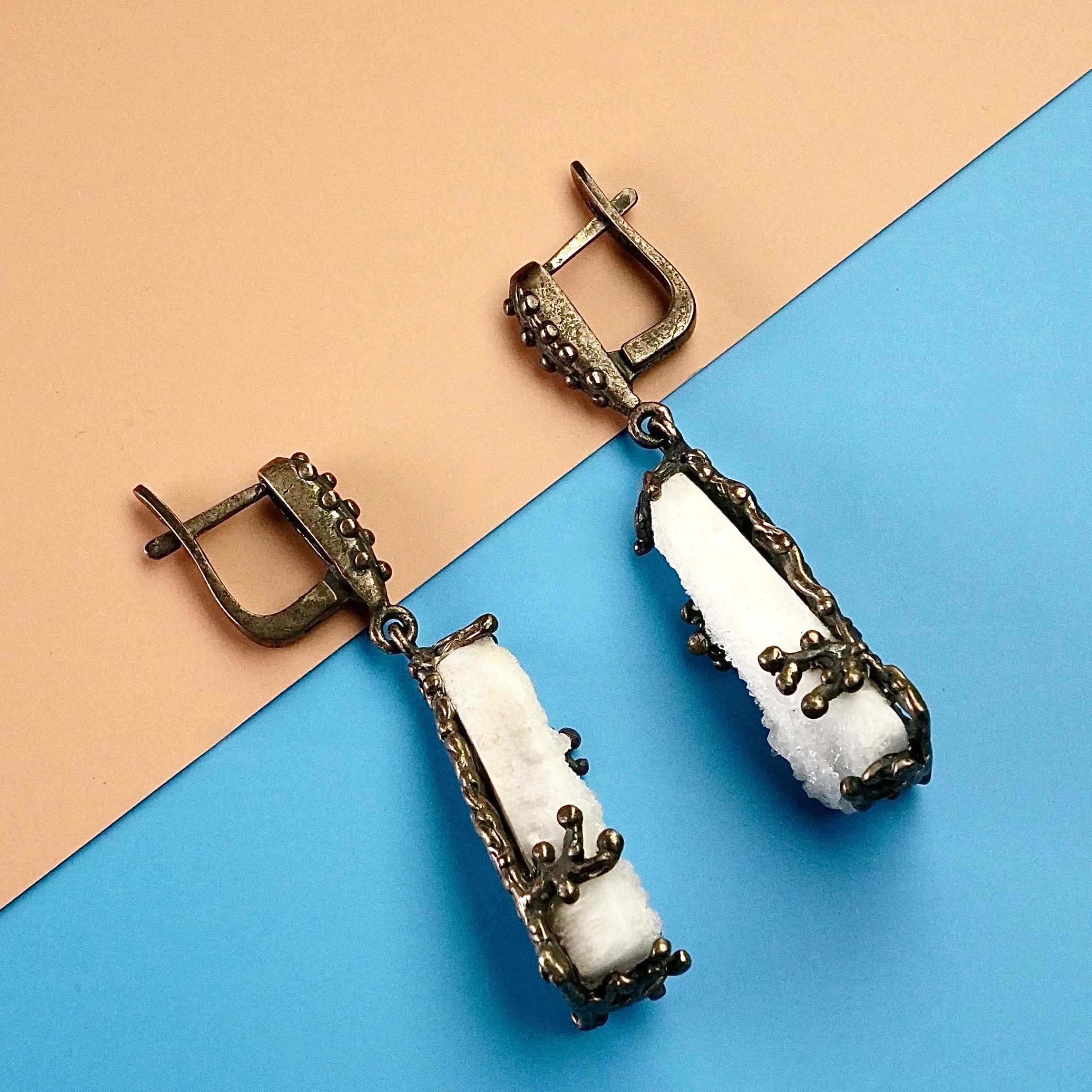 Angle view moonstone earrings raw crystal silver drop earrings perspective