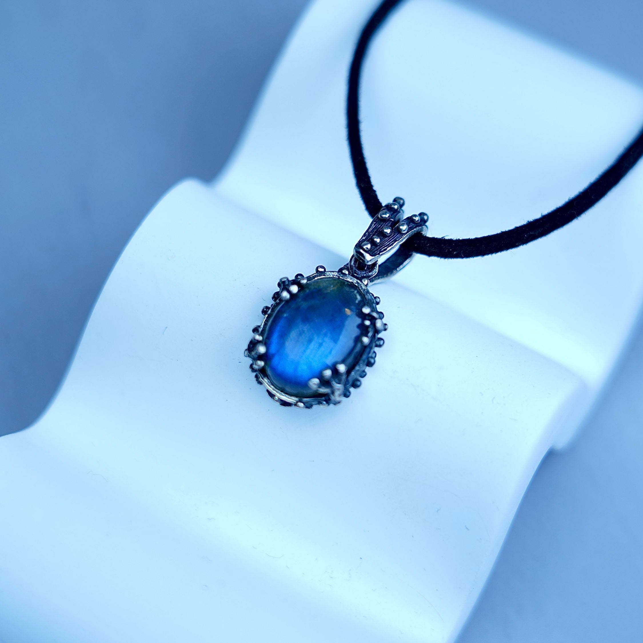 Angle view labradorite pendant blue flash gemstone silver necklace perspective