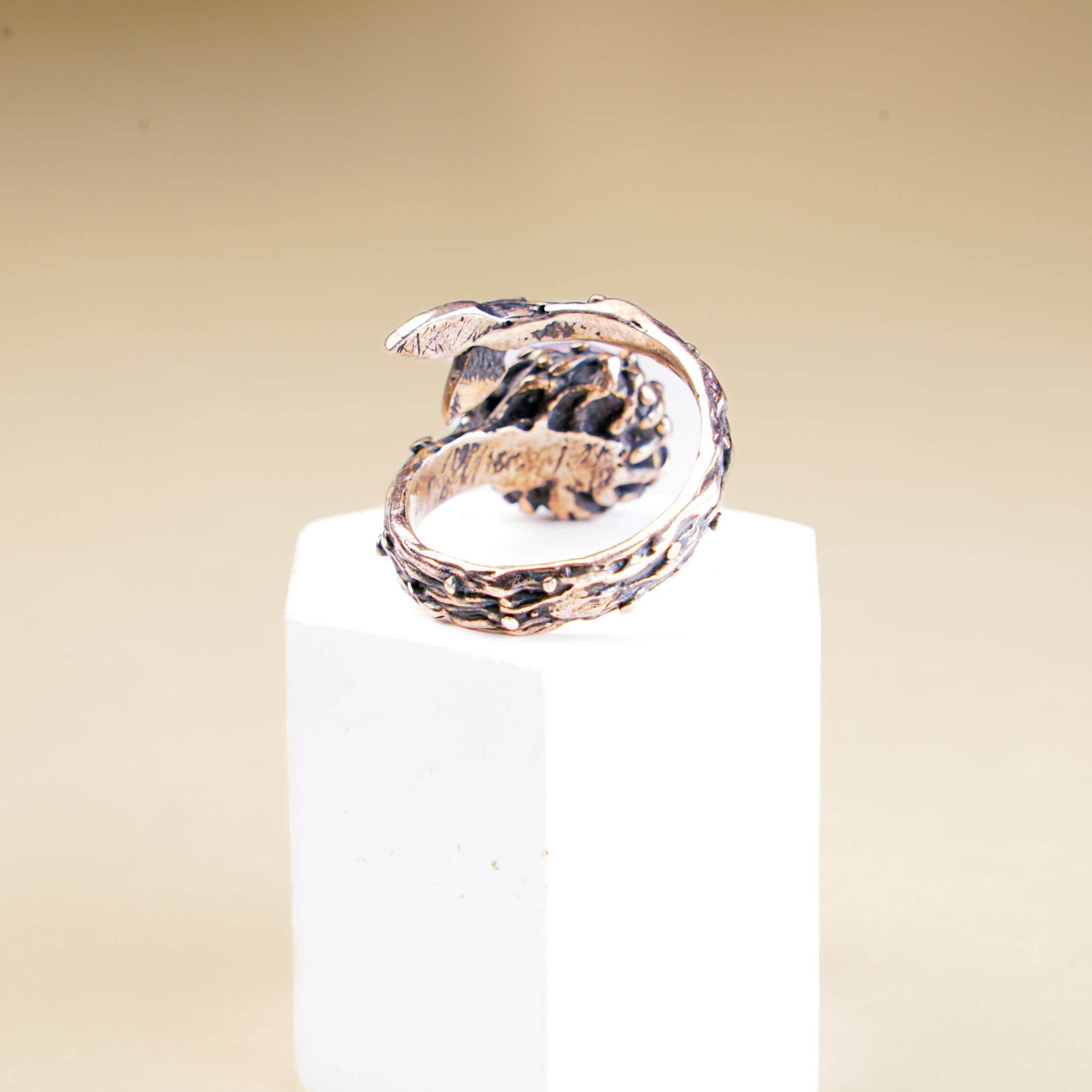 Functional view of the adjustable open-back silver band for a rose quartz statement ring