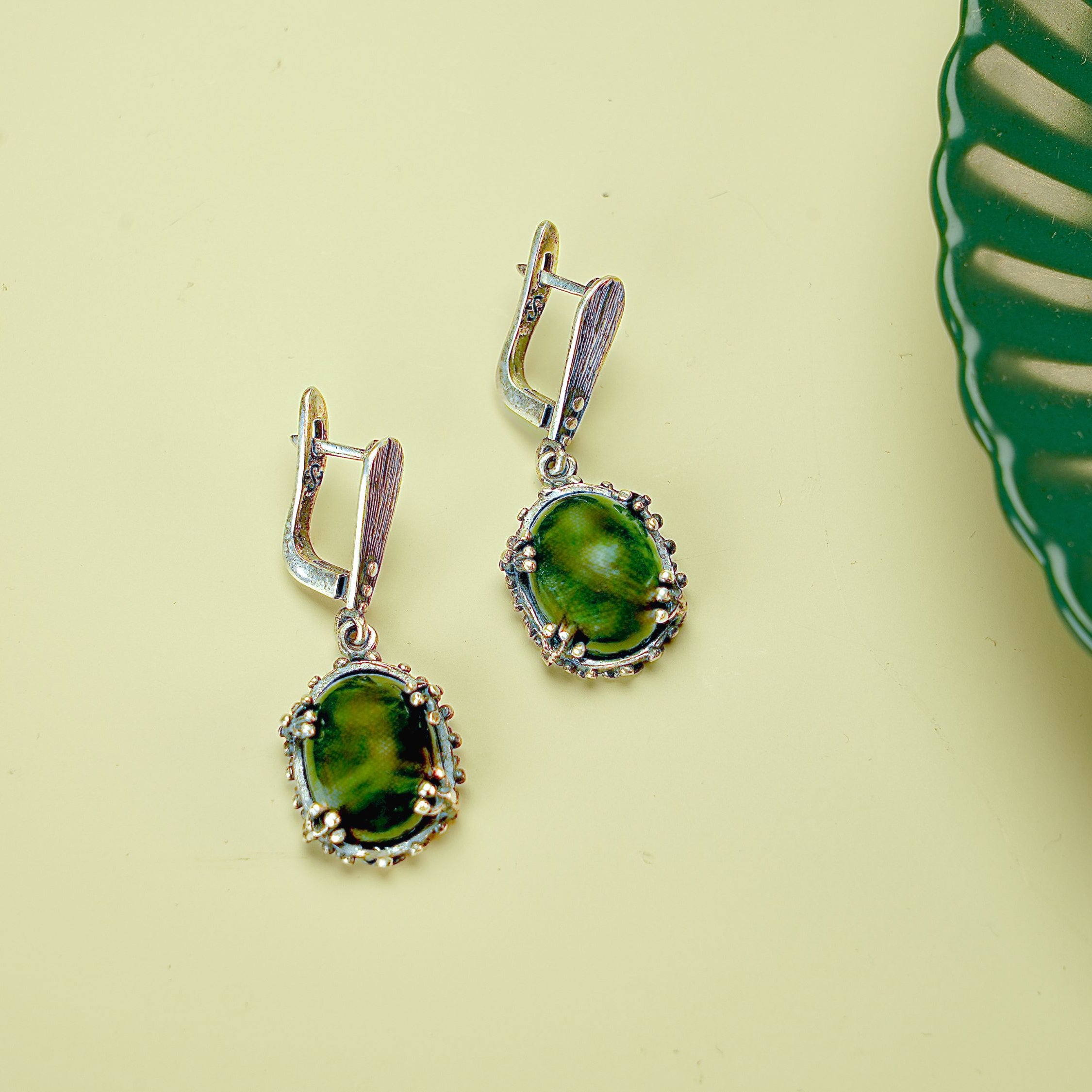 Angle view jade earrings green gemstone silver leverback earrings perspective