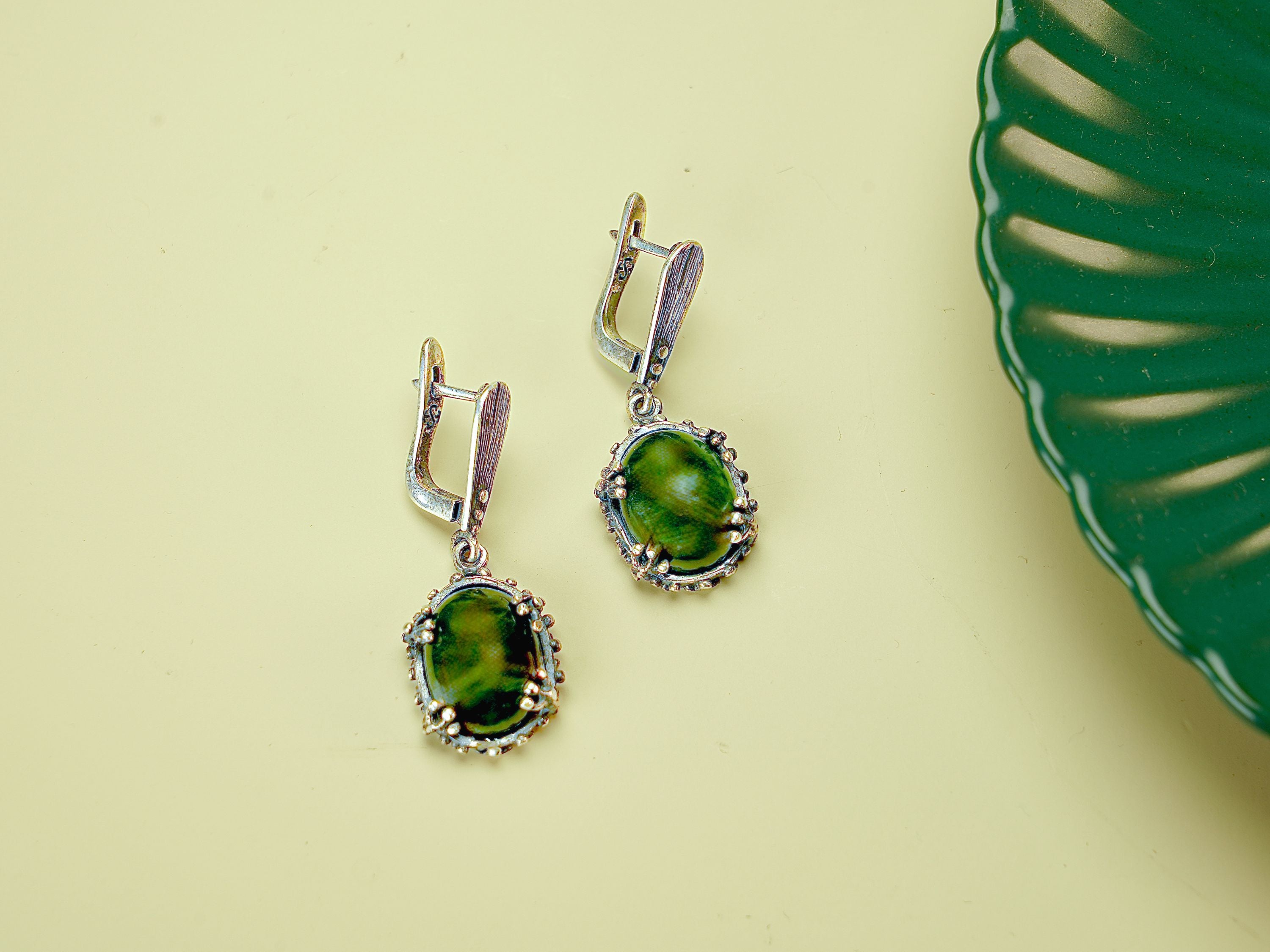 Angle view jade earrings green gemstone silver leverback earrings perspective