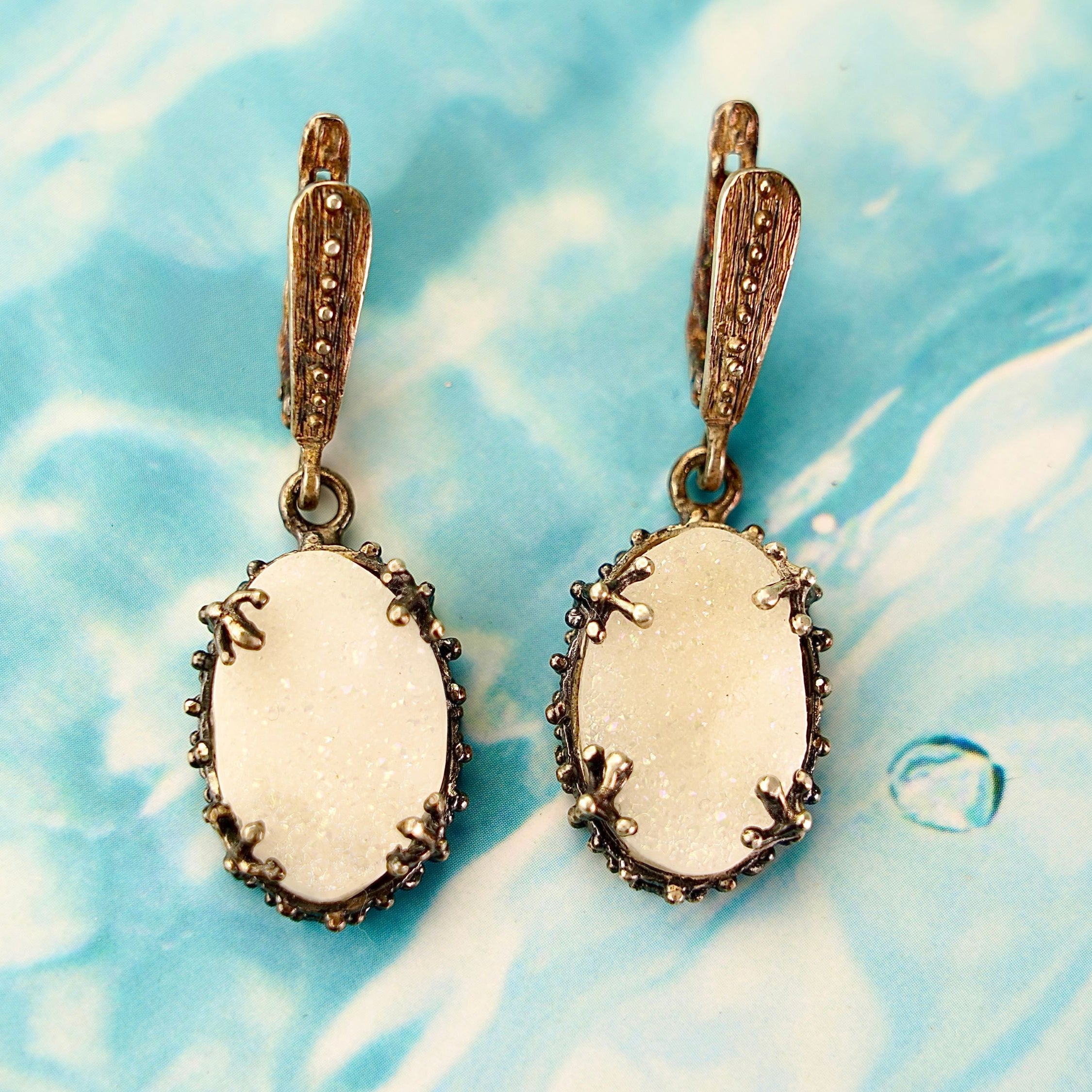 Angle view moonstone drop earrings glow stone silver dangle earrings perspective