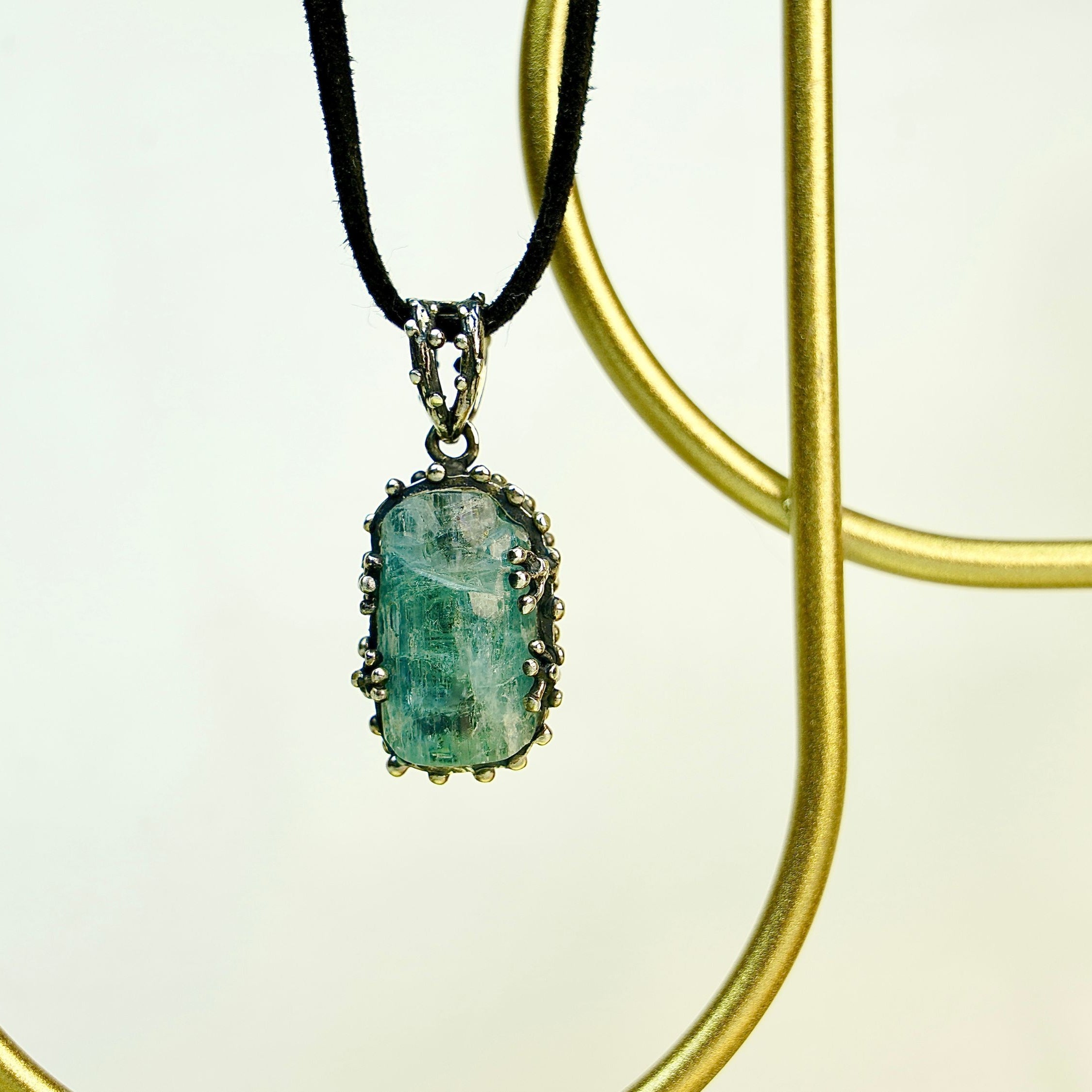 Angle view aquamarine pendant raw blue gemstone silver necklace elegant perspective
