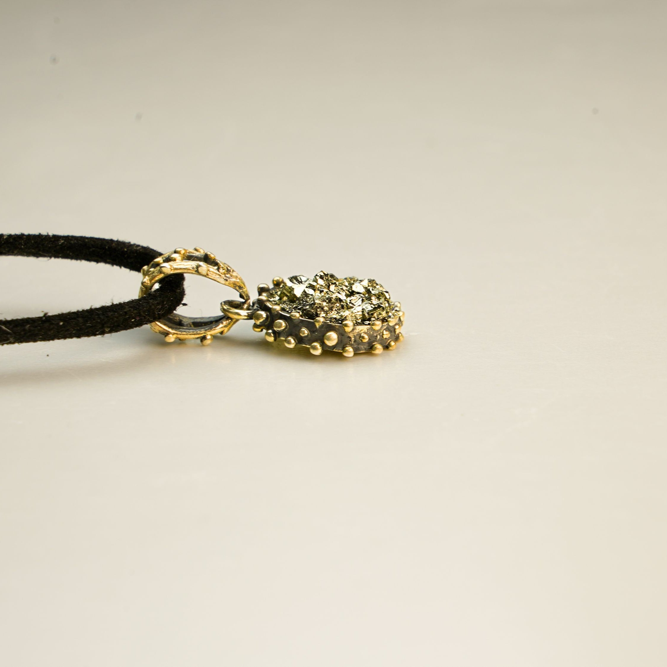 gold pyrite pendant angle view sterling silver handmade jewelry