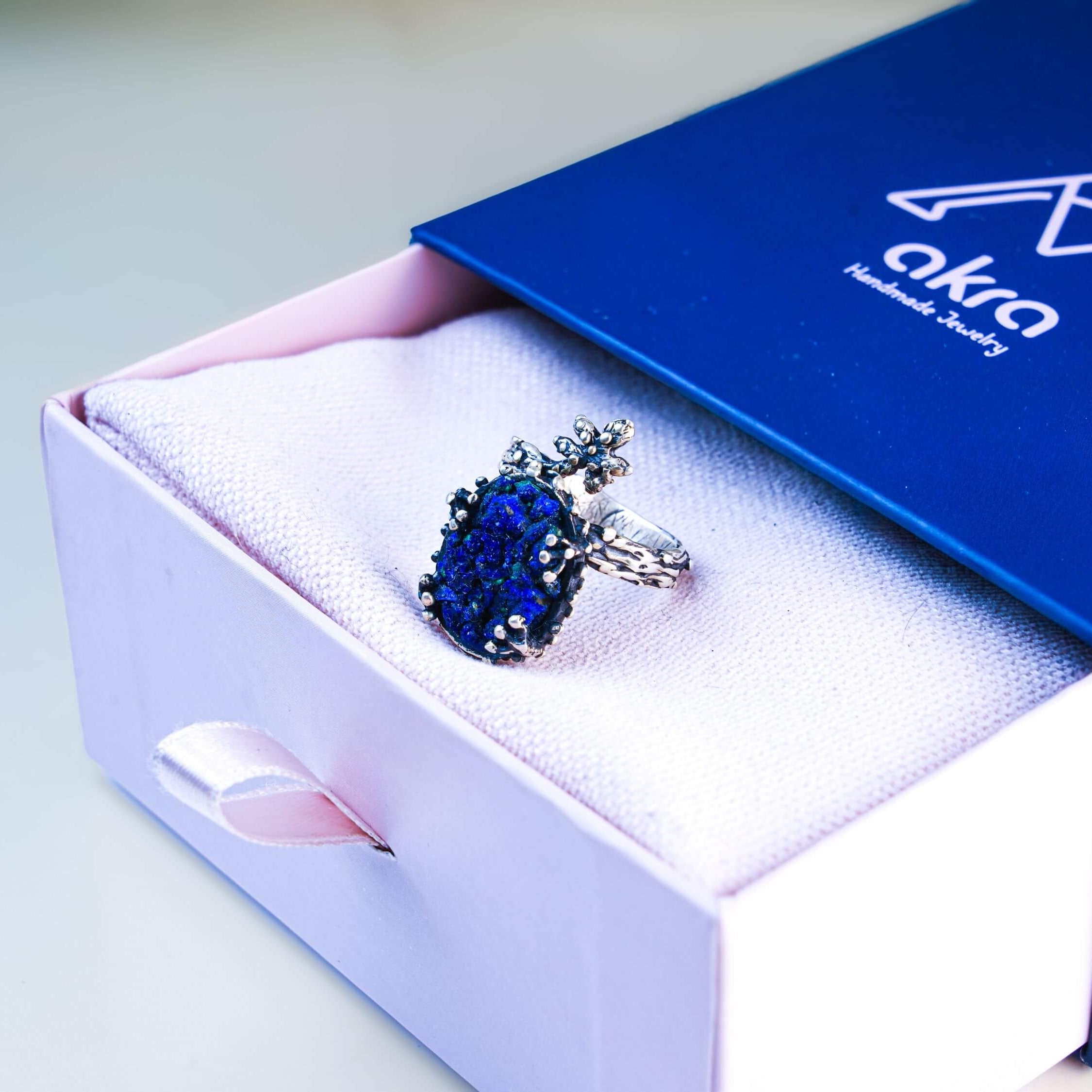 Lapis lazuli twig ring presented in Akra Gems signature blue and pink luxury jewelry box