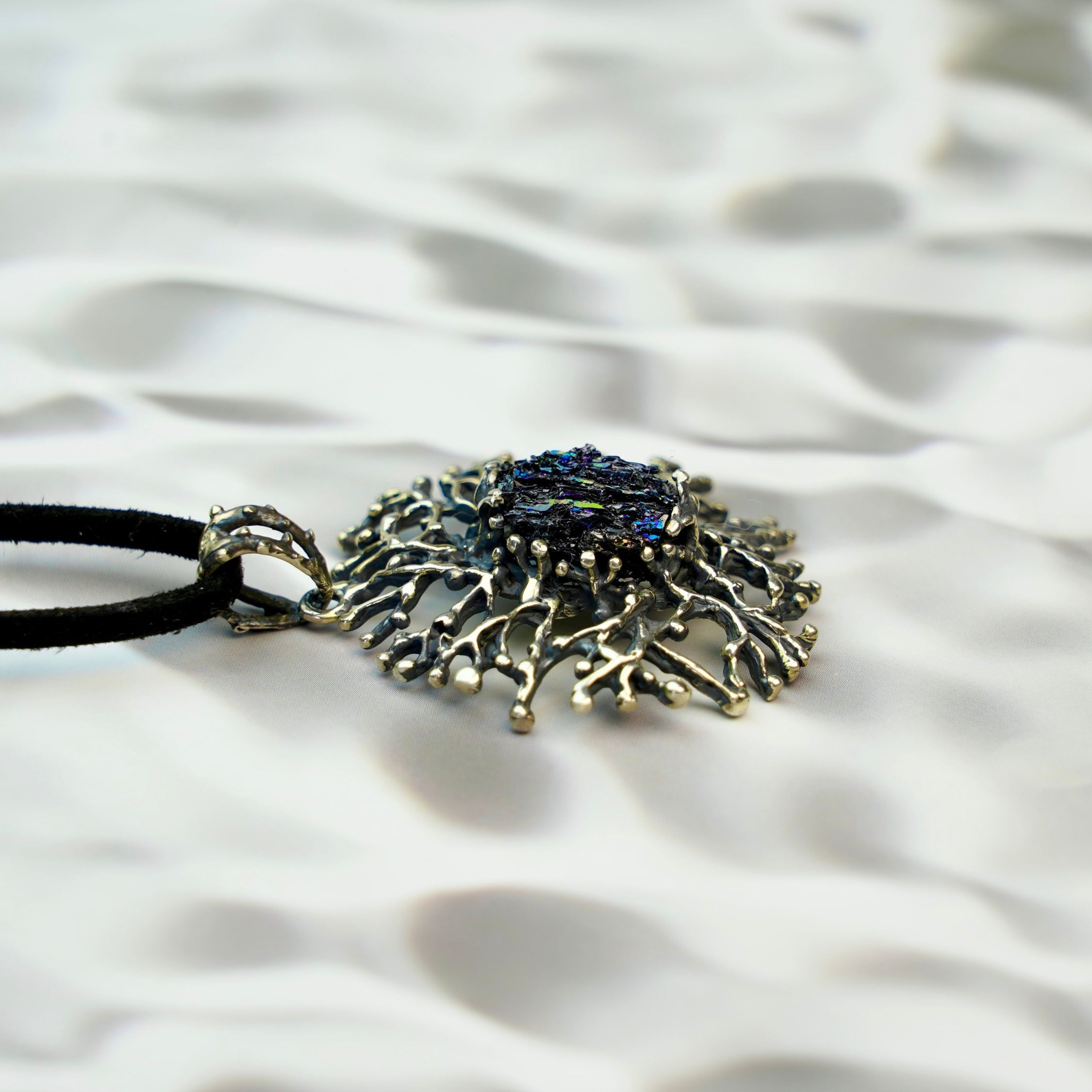 tourmaline pendant side profile, sculptural silver setting and crystal depth